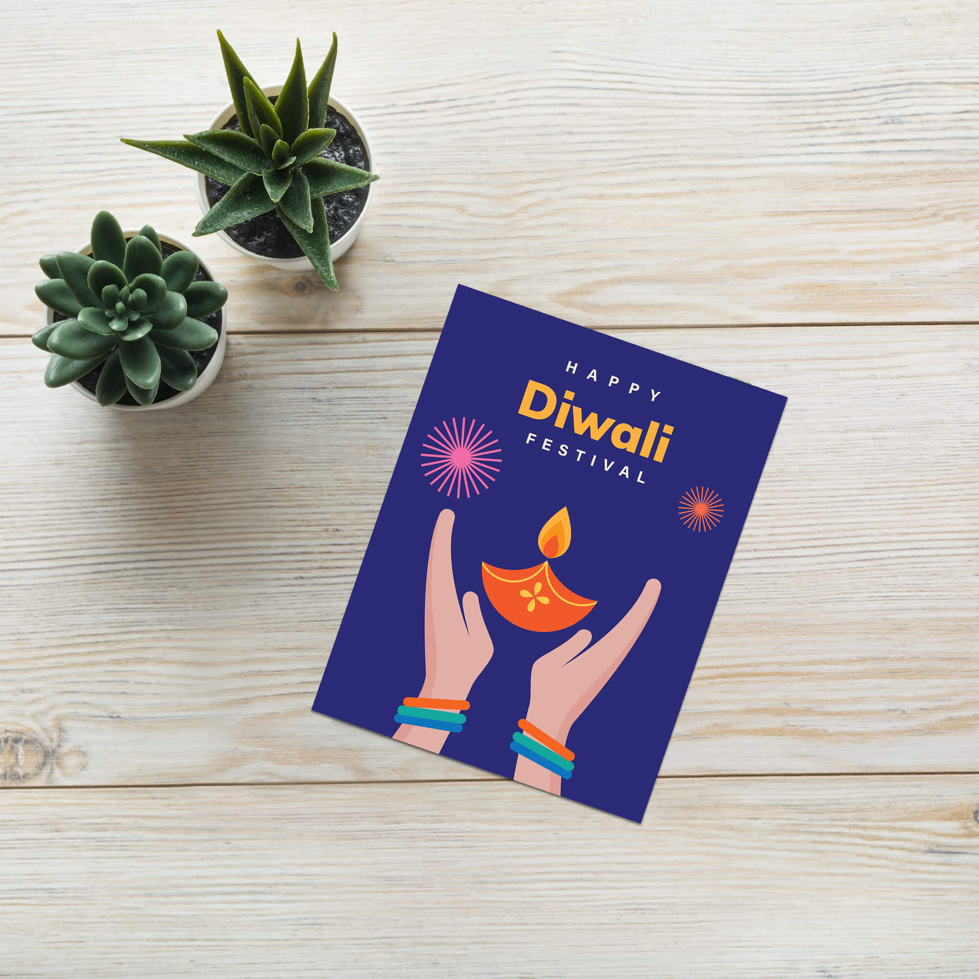 Diwali card with hands holding a lamp on a wooden surface with plants.