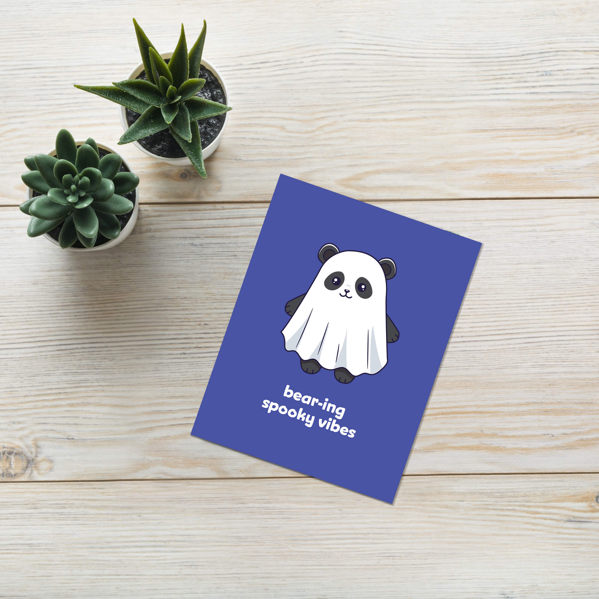 kawaii halloween Greeting card with a panda bear ghost illustration and text on a blue background