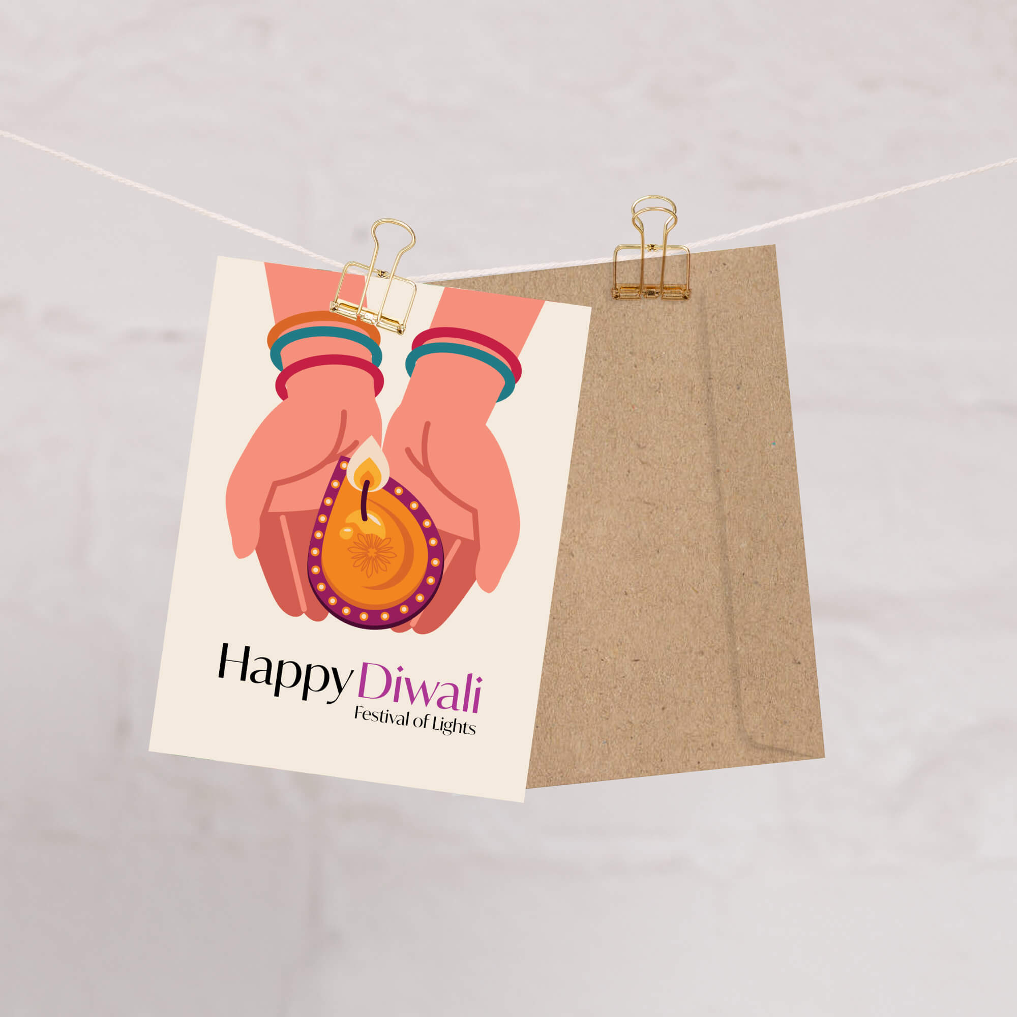 indian Greeting card with hands holding a Diwali lamp and 'Happy Diwali' text, hanging on a string.