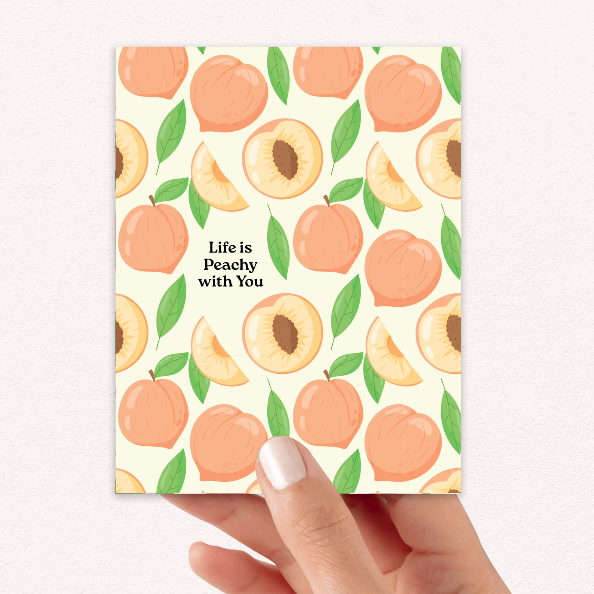 Note card with peach pattern and 'Life is Peachy with You' text, held by a hand.