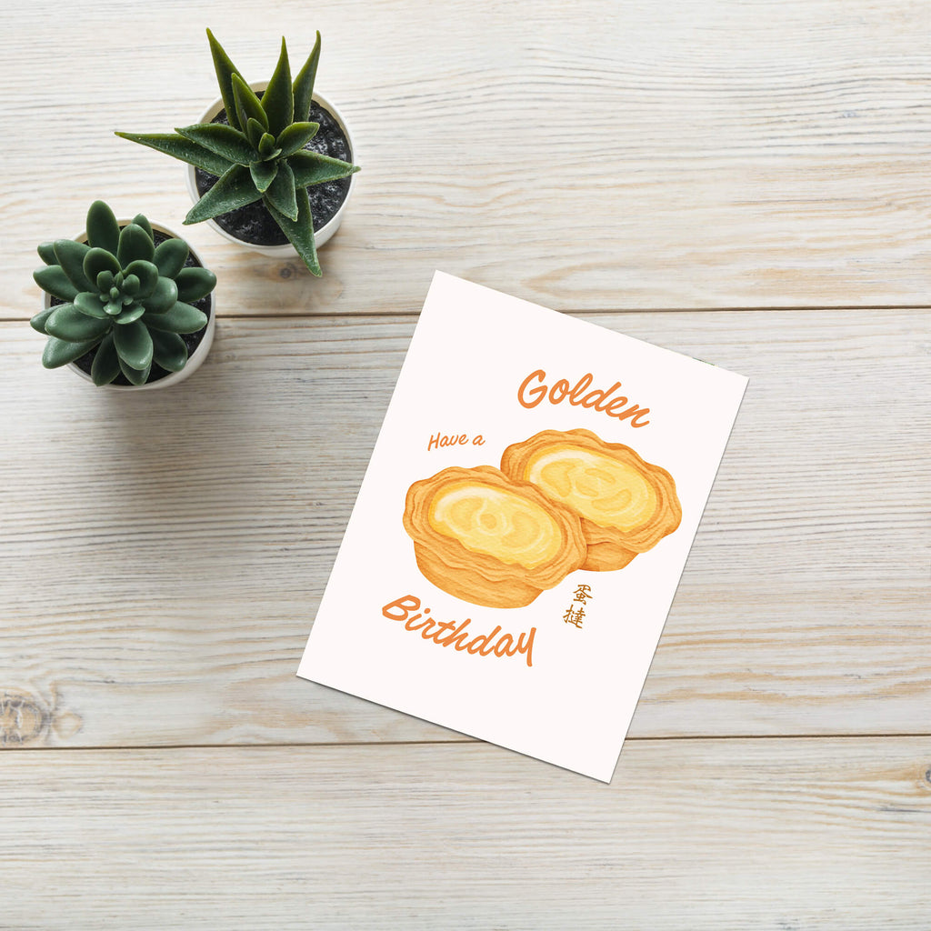 asian birthday Greeting card with two golden egg tart pastries and 'Have a Golden Birthday' text on a white background.