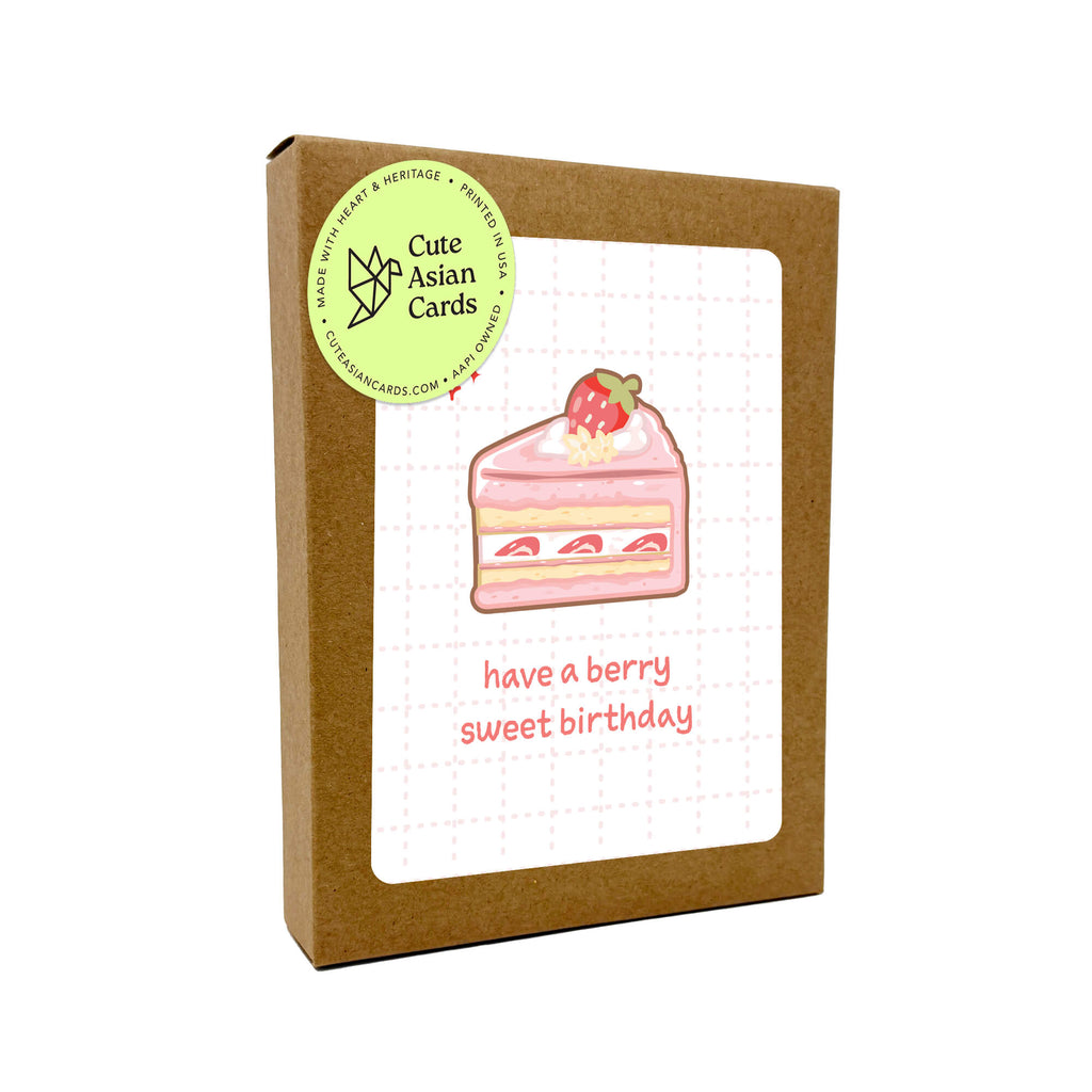 boxed set of birthday cards with a slice of cake illustration and text 'have a berry sweet birthday' on a white background.