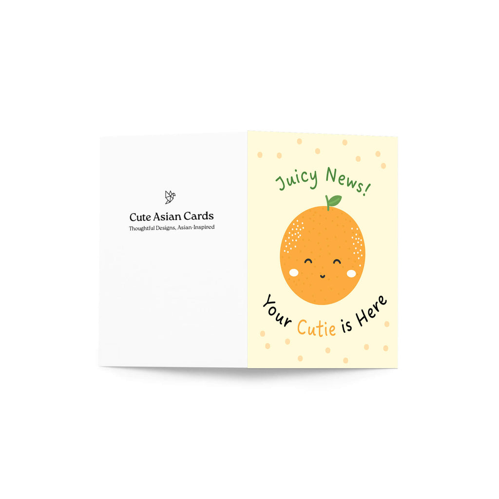 A folded new baby card shown open against a white background. The left panel is white with the brand name 'Cute Asian Cards' printed in black.