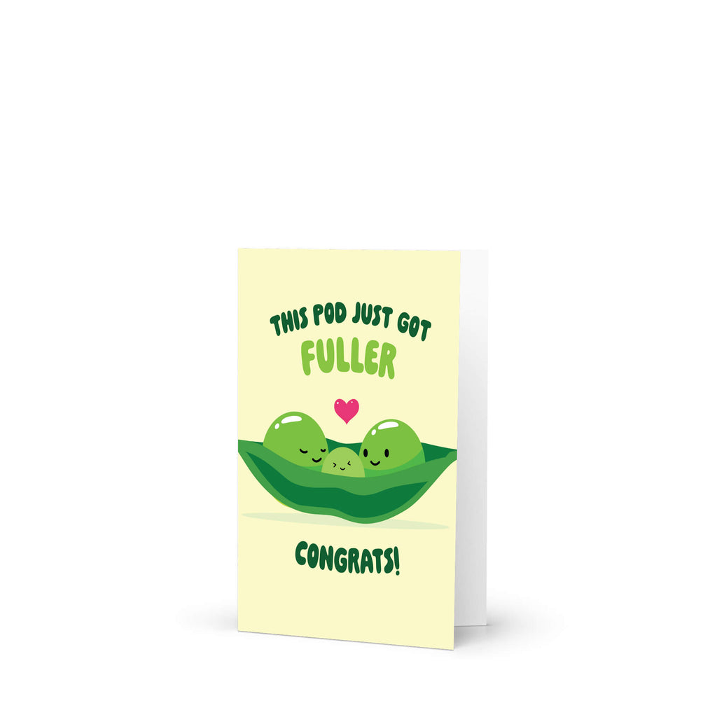 A vertical greeting card with a pale yellow front and white backing, featuring a cute green pea pod illustration with three smiling green peas and a small pink heart. The text reads 'THIS POD JUST GOT FULLER CONGRATS!' in dark green and light green lettering.