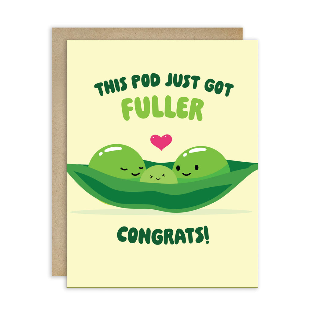 A Japanese inspired baby shower card with a kraft envelope behind it, featuring a cute illustration of three green peas in a pod with a small pink heart and the text 'THIS POD JUST GOT FULLER CONGRATS!'.