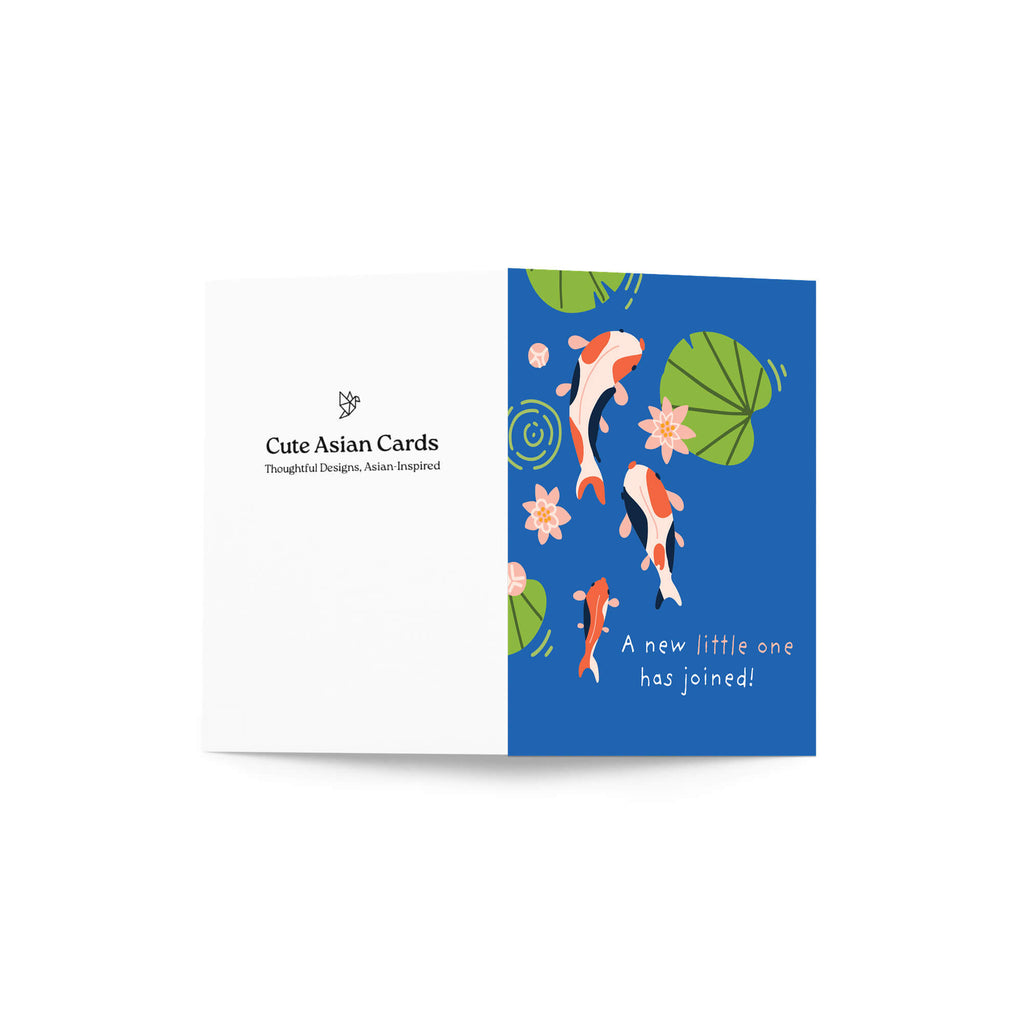 A folded baby shower card shown open against a white background. The left panel is white with the text 'Cute Asian Cards' and a small floral icon.