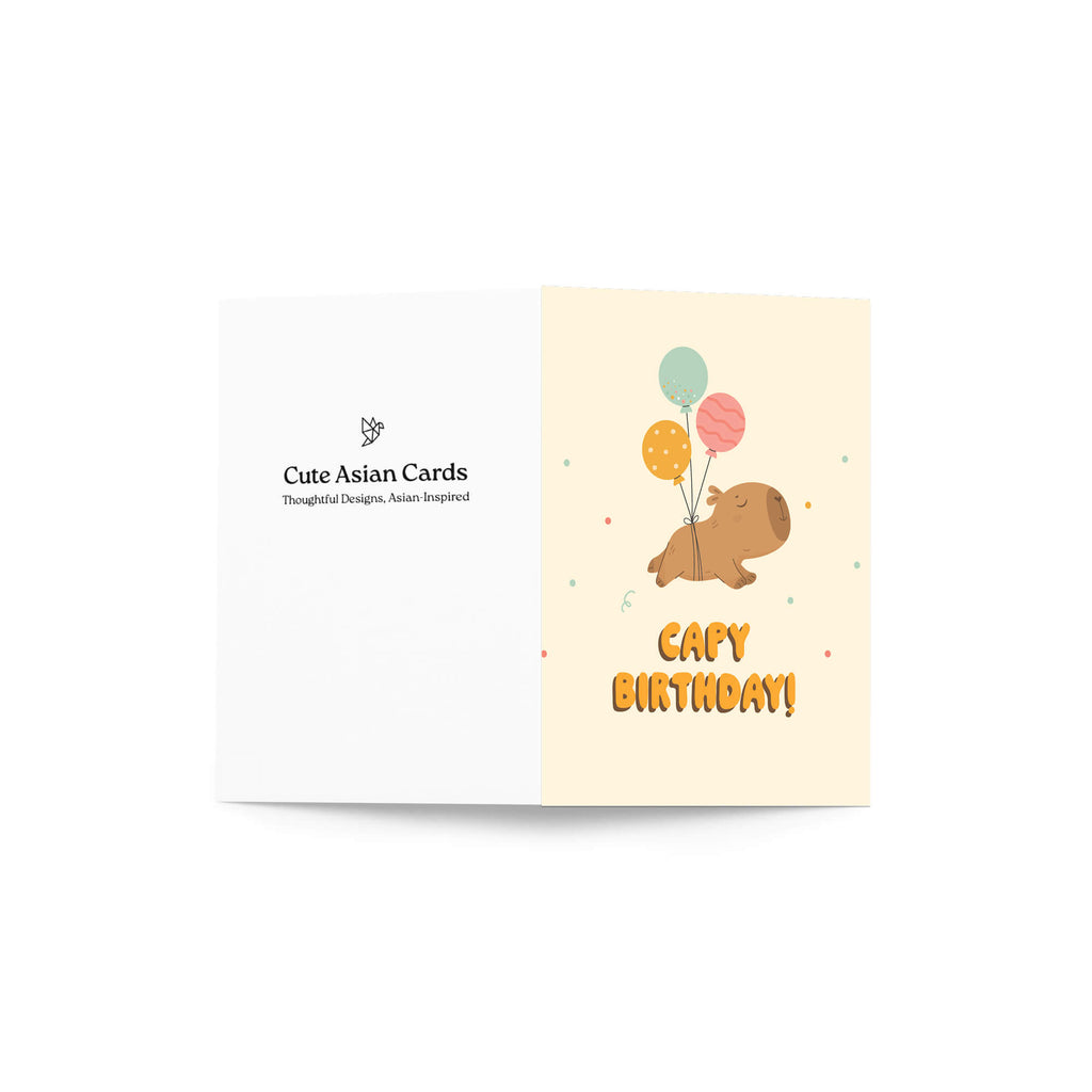 A folded greeting card shown open against a white background. The left panel is white with the text 'Cute Asian Cards' and a small logo.