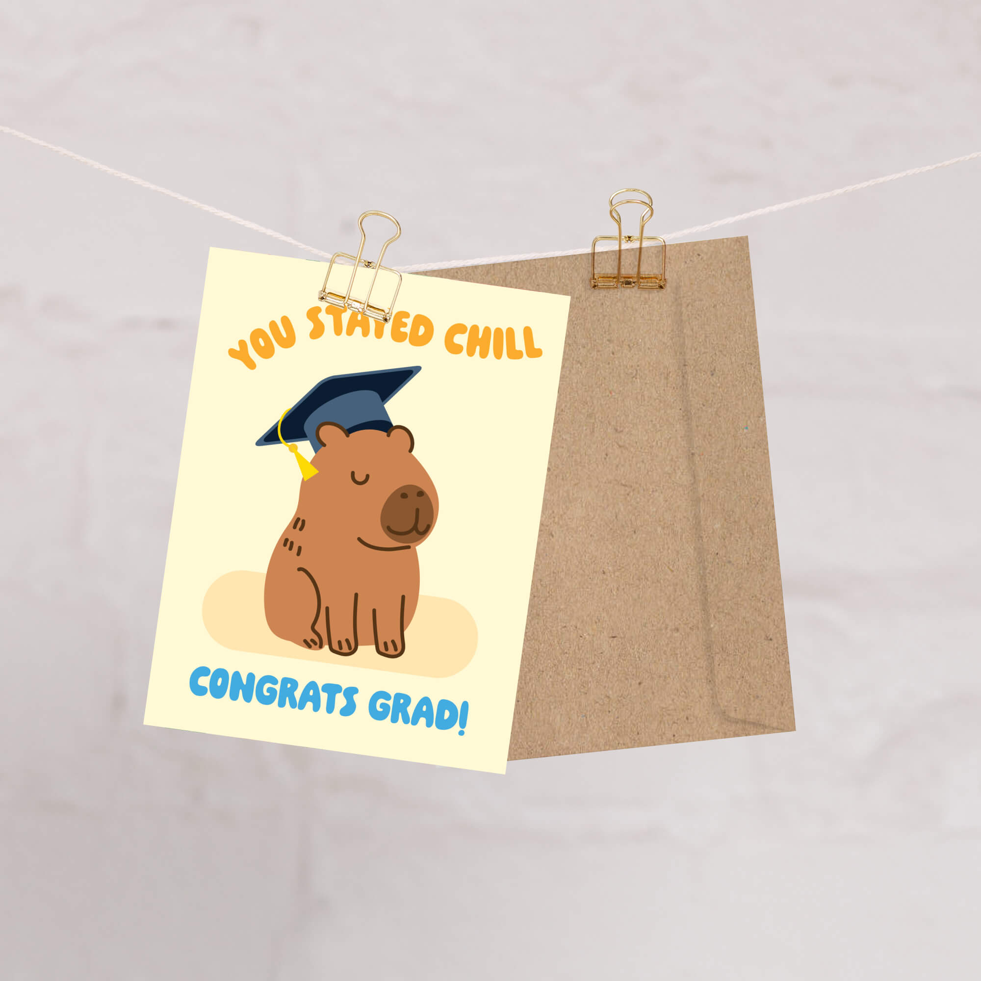 cute Graduation card with a capybara wearing a cap and 'You Stayed Chill Congrats Grad!' text on a yellow background.