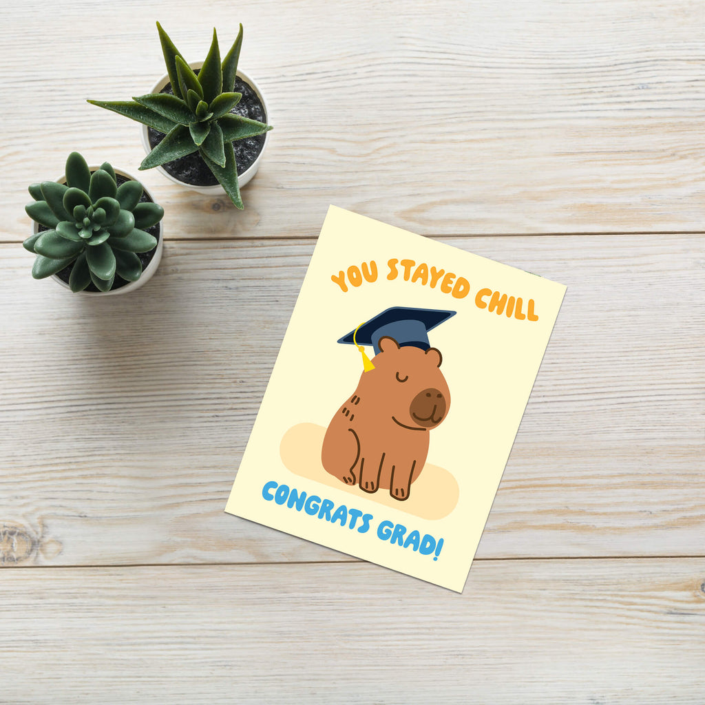cute Graduation card with a capybara wearing a cap and 'You Stayed Chill Congrats Grad!' text on a yellow background.