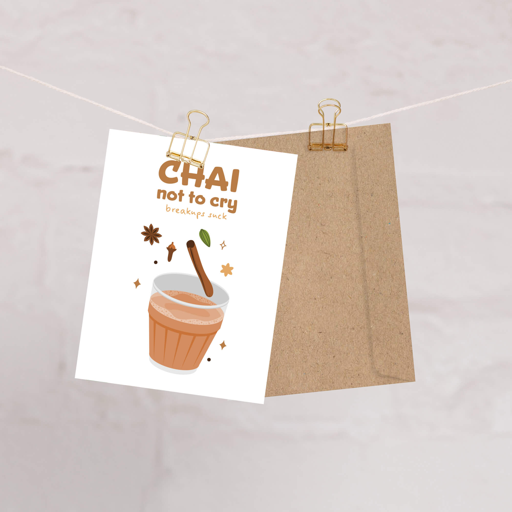 divorce card with 'Chai not to cry' text and a cup illustration, attached to a string with clips.