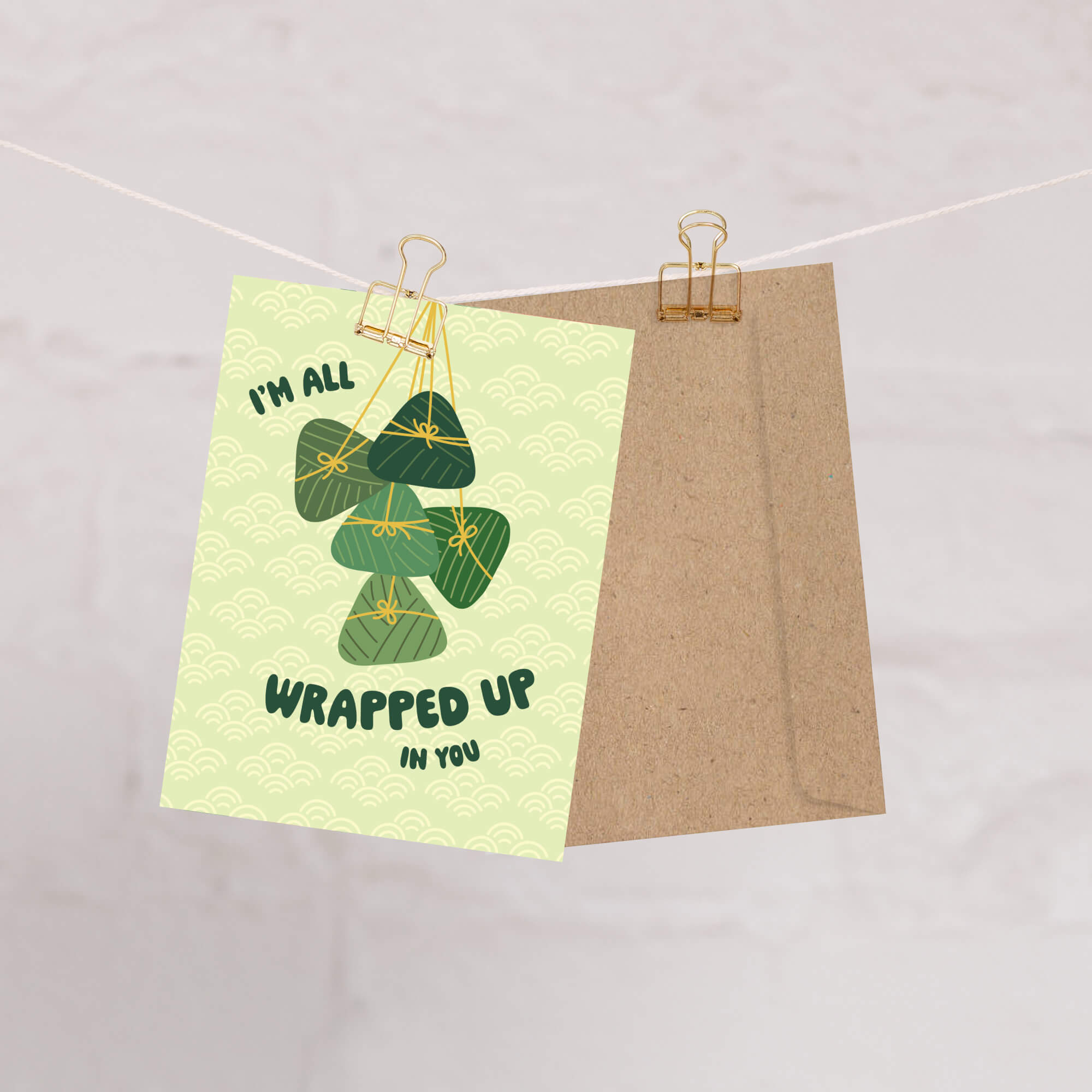 Greeting card with green banana leaf zong zi chinese tamale illustrations and text on a light green background