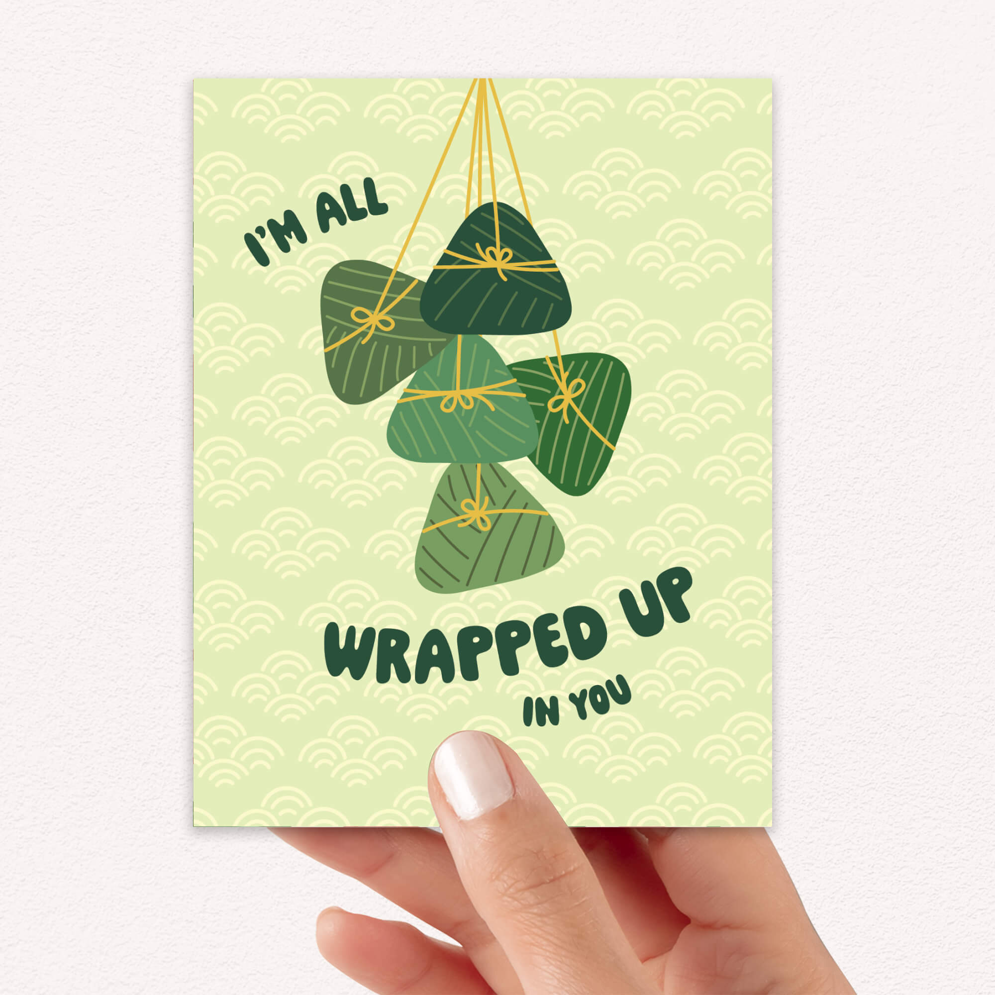 Greeting card with green banana leaf zong zi chinese tamale illustrations and text on a light green background dragon boat festival