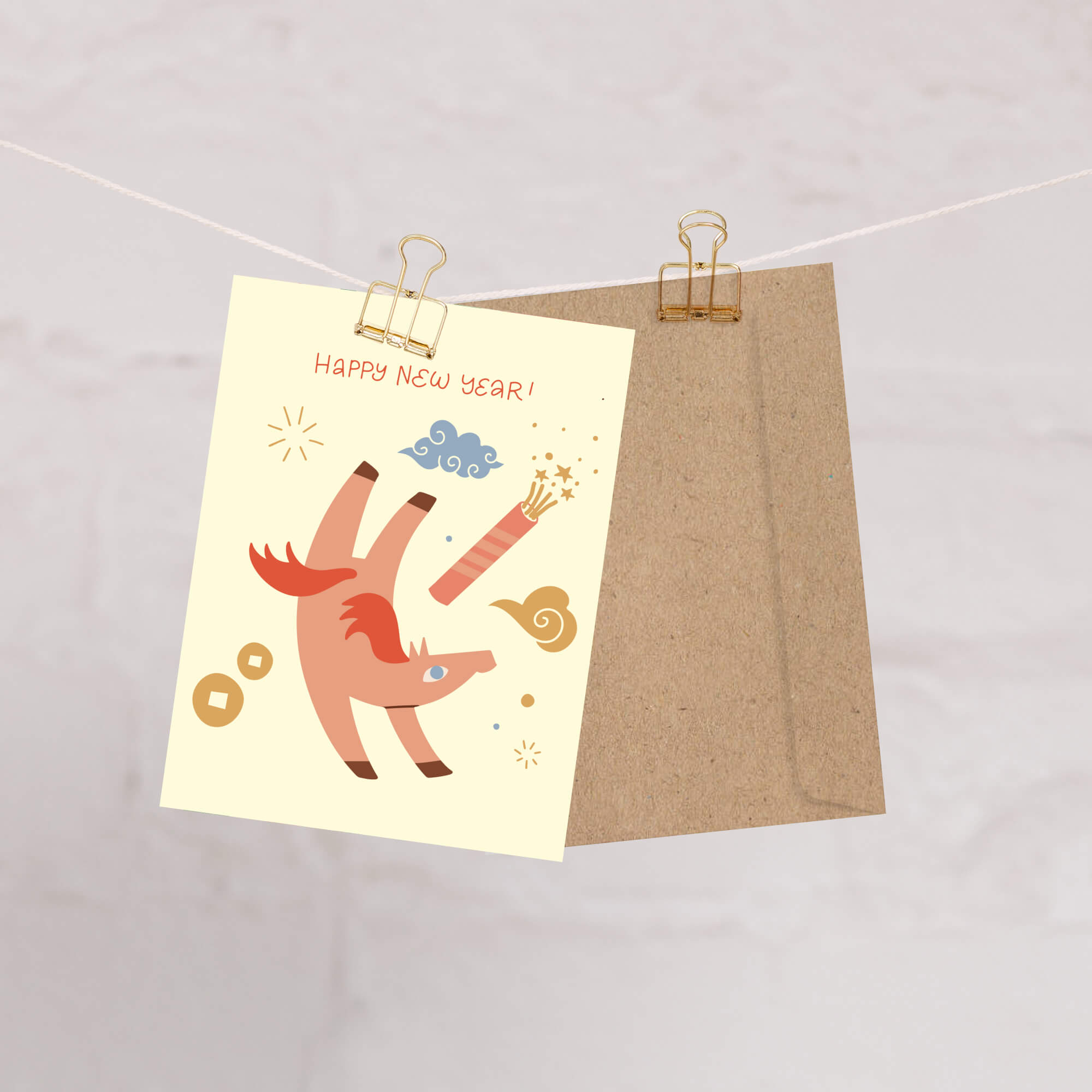 Happy chinese New Year card with a cartoon horse  design on a beige background, clipped to a string.