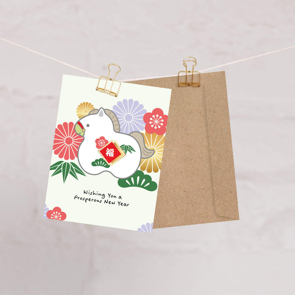 lunar new year greeting Card with a horse design and floral elements, hanging on a string with a brown envelope.