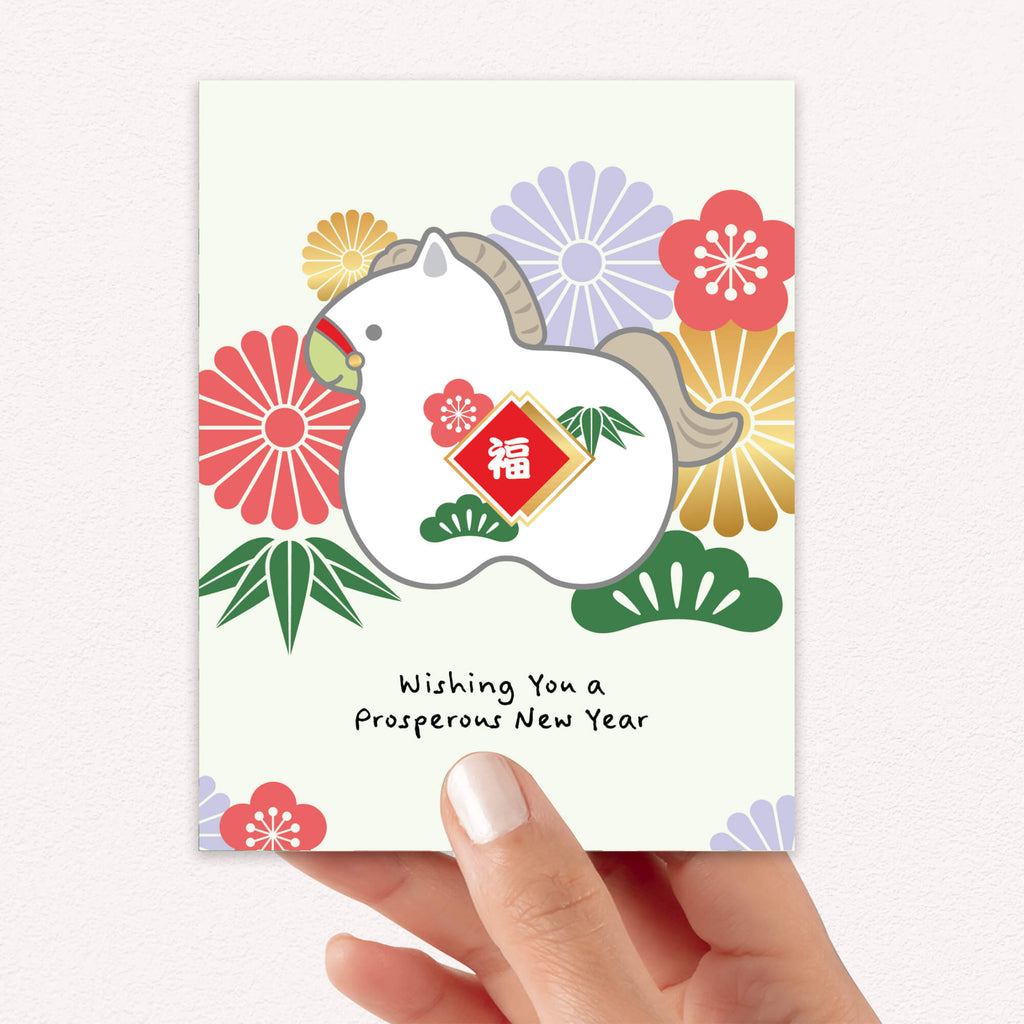 lunar new year greeting Card with a horse design and floral elements, hanging on a string with a brown envelope.