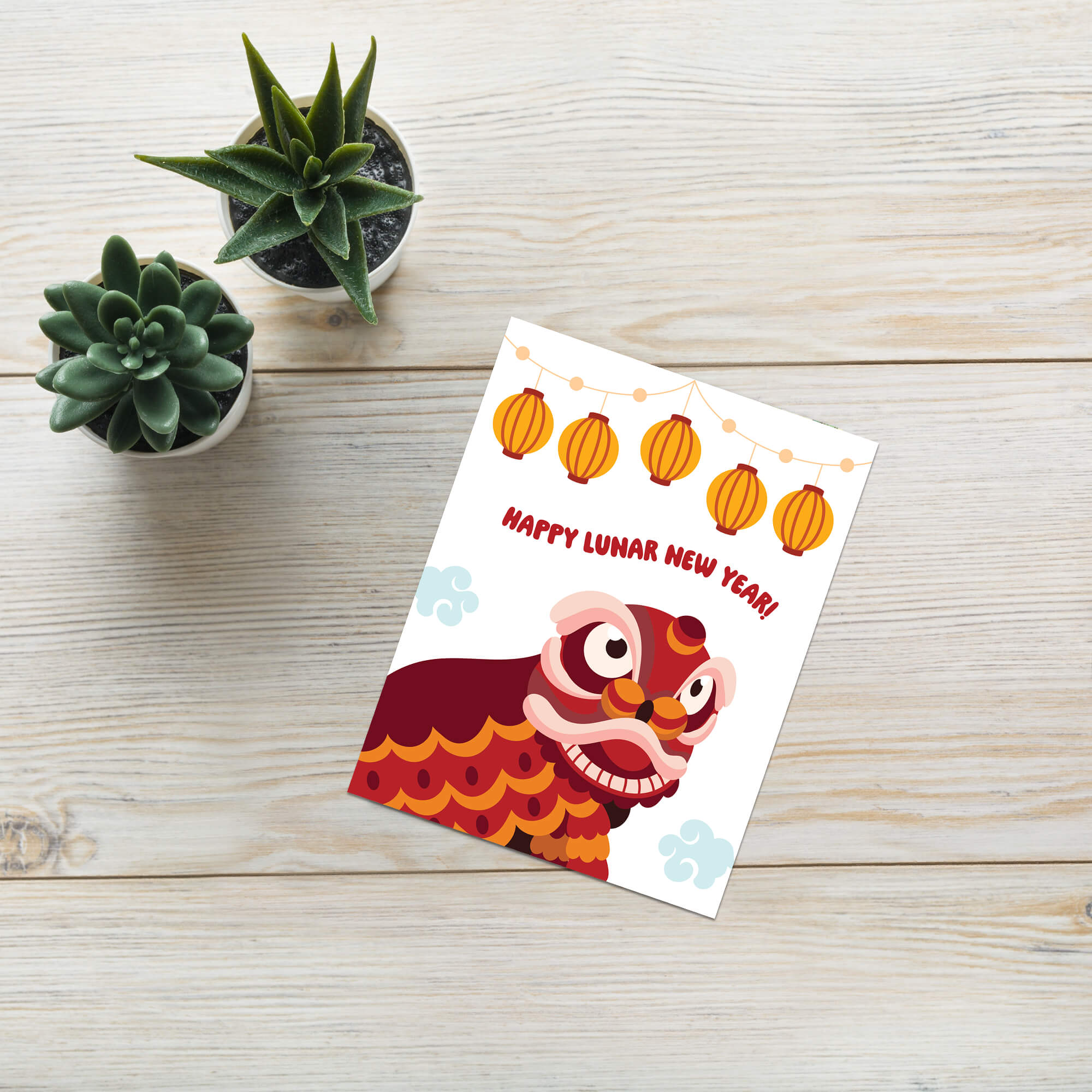 chinese new year Greeting card with a lion dance design and 'Happy Lunar New Year!' text on a wooden surface with small plants.