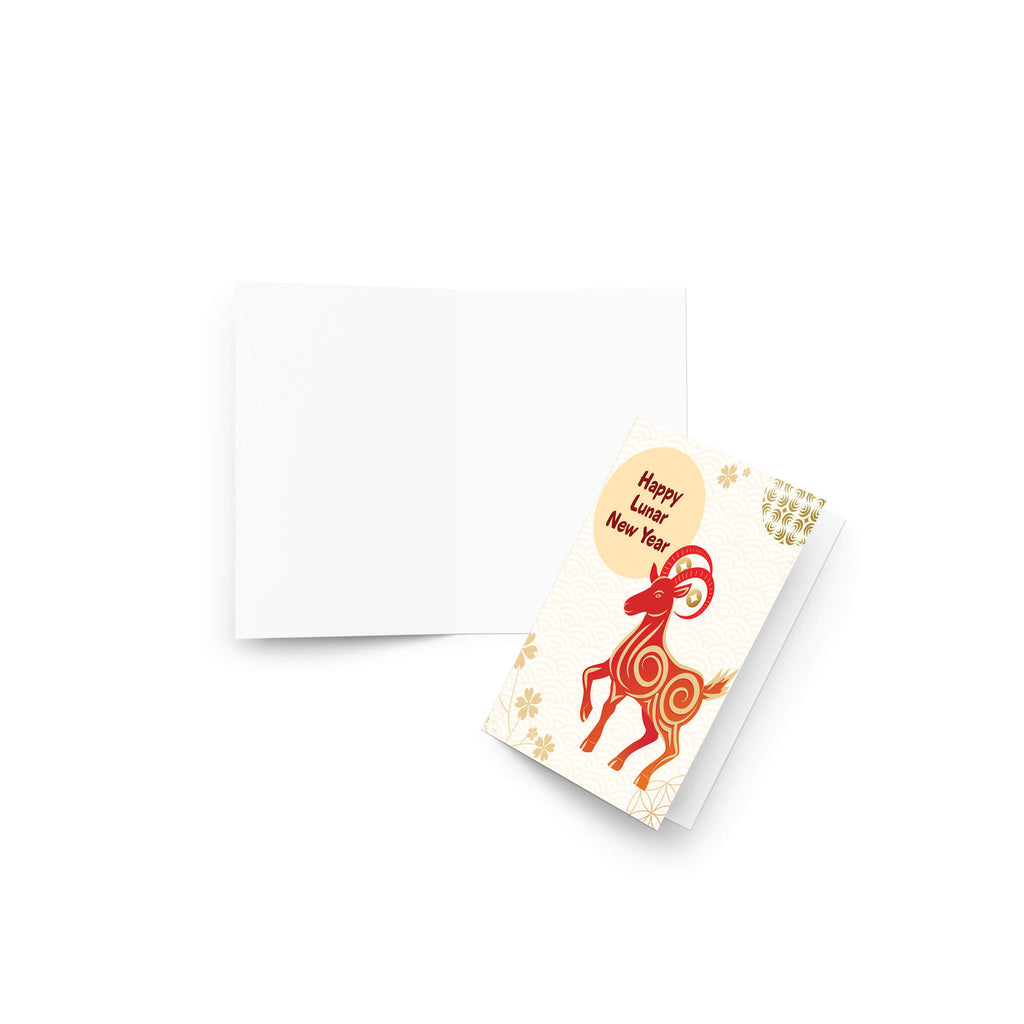 A Year of the Goat card featuring a folded white card and its front cover, which displays a red and orange ram illustration and a gold circle reading 'Happy New Year'.