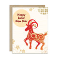 A lunar new year card with a kraft envelope, featuring a stylized red and orange ram illustration and the text 'Happy Lunar New Year' on a cream background with gold wave and floral motifs.