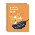Greeting card with a wok and noodles illustration and text on an orange background