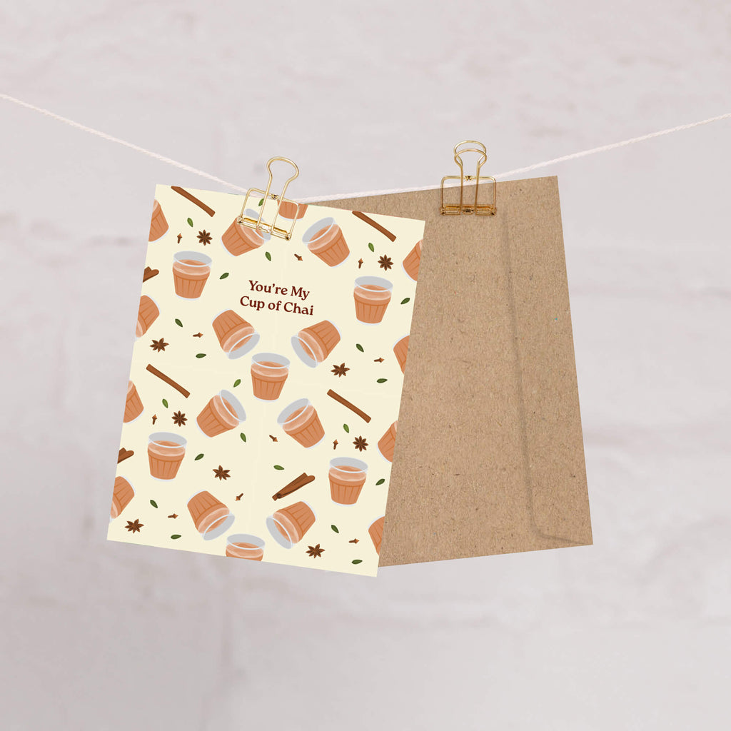 indian desi Greeting card with cup of chai pattern and text 'You're My Cup of Chai' on a beige background.