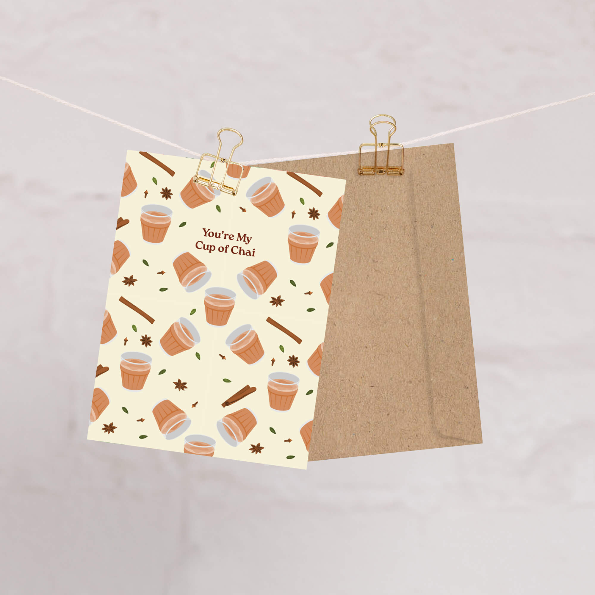 indian desi Greeting card with cup of chai pattern and text 'You're My Cup of Chai' on a beige background.
