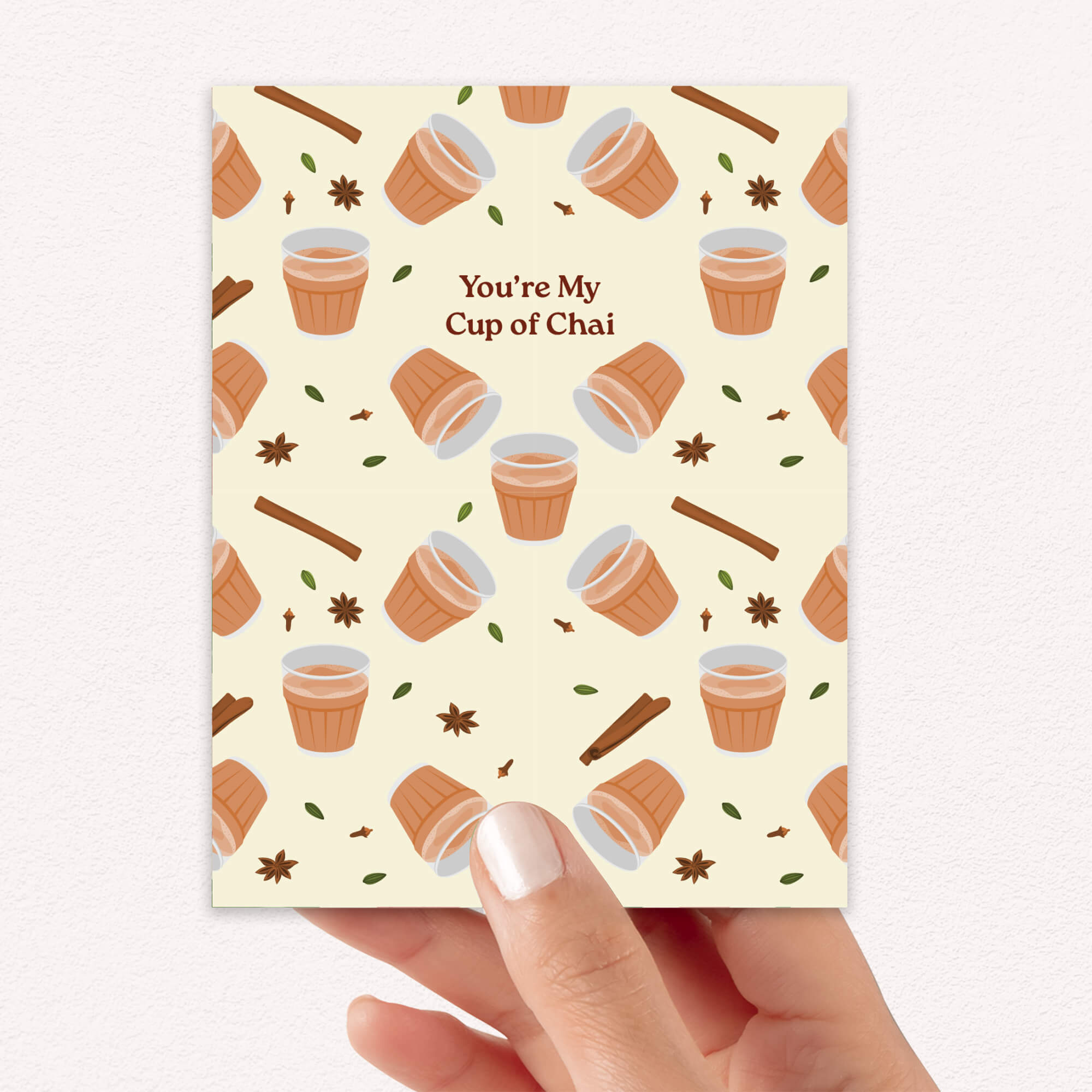 indian desi Greeting card with cup of chai pattern and text 'You're My Cup of Chai' on a beige background.