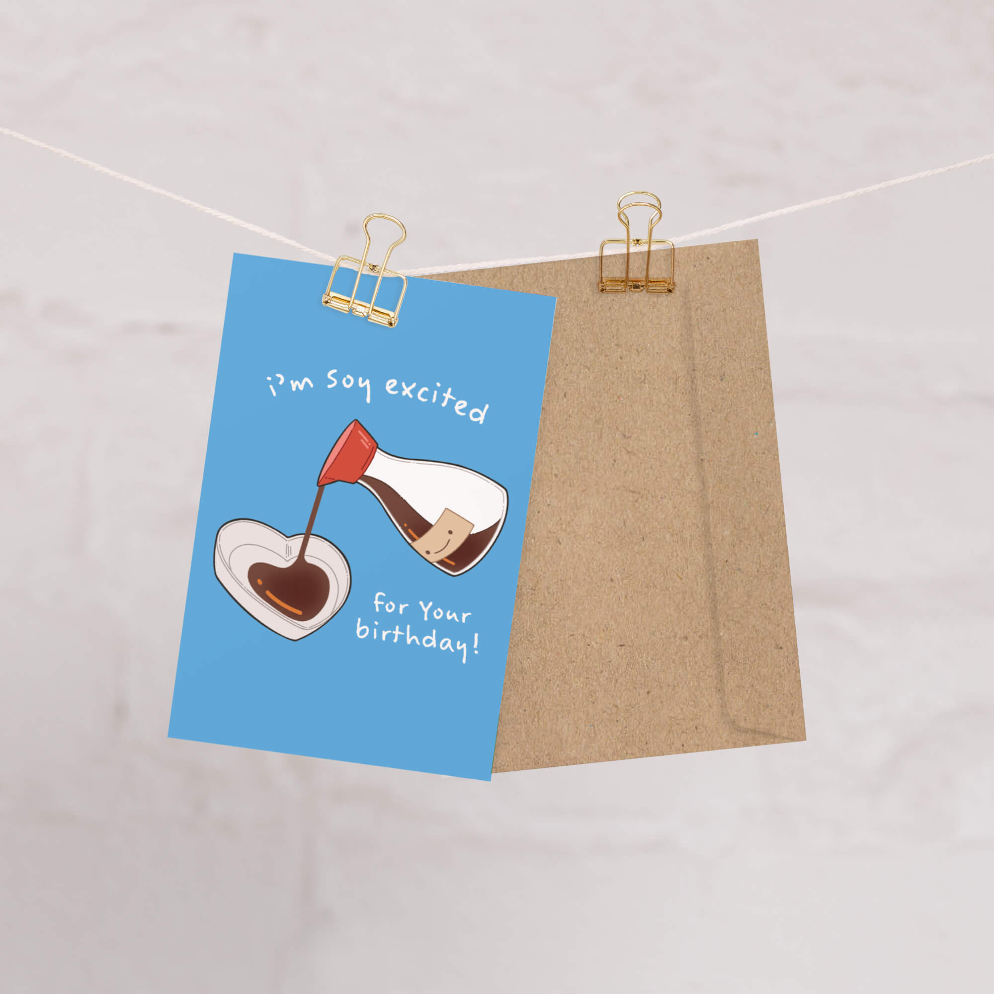 Greeting card with a blue background and brown envelope, featuring a design of a glass of red wine being poured into a heart shape, with text 'I'm so excited for your birthday!' on a light gray background.