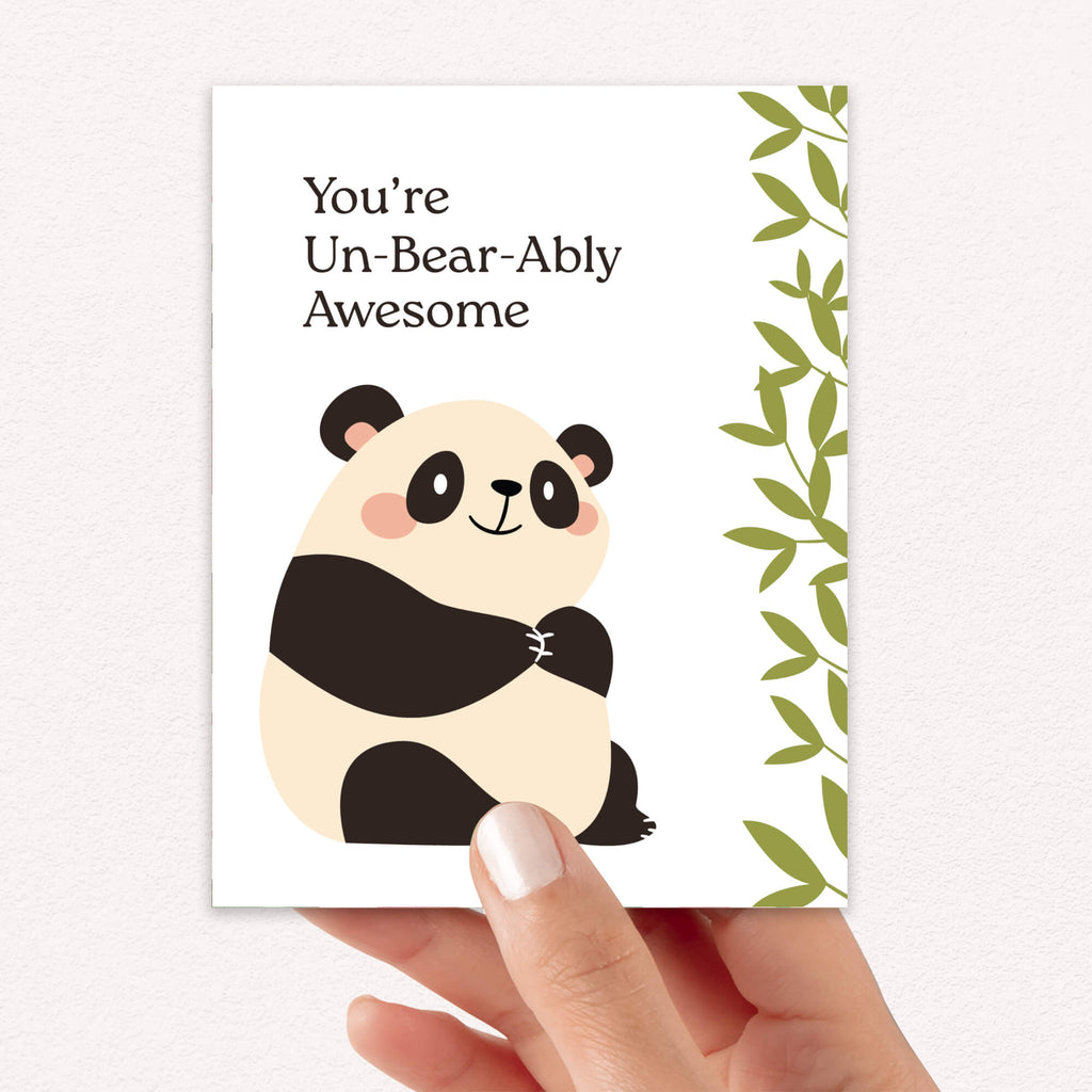 Card with a panda illustration and text 'You're Un-Bear-Ably Awesome' held by a hand.