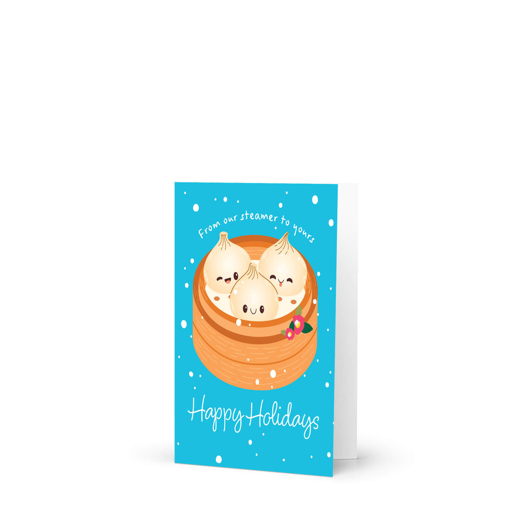 cute christmas greeting card with Three cute soup dumplings in bamboo steamer on teal snow with “From our steamer to yours. Happy Holidays.”