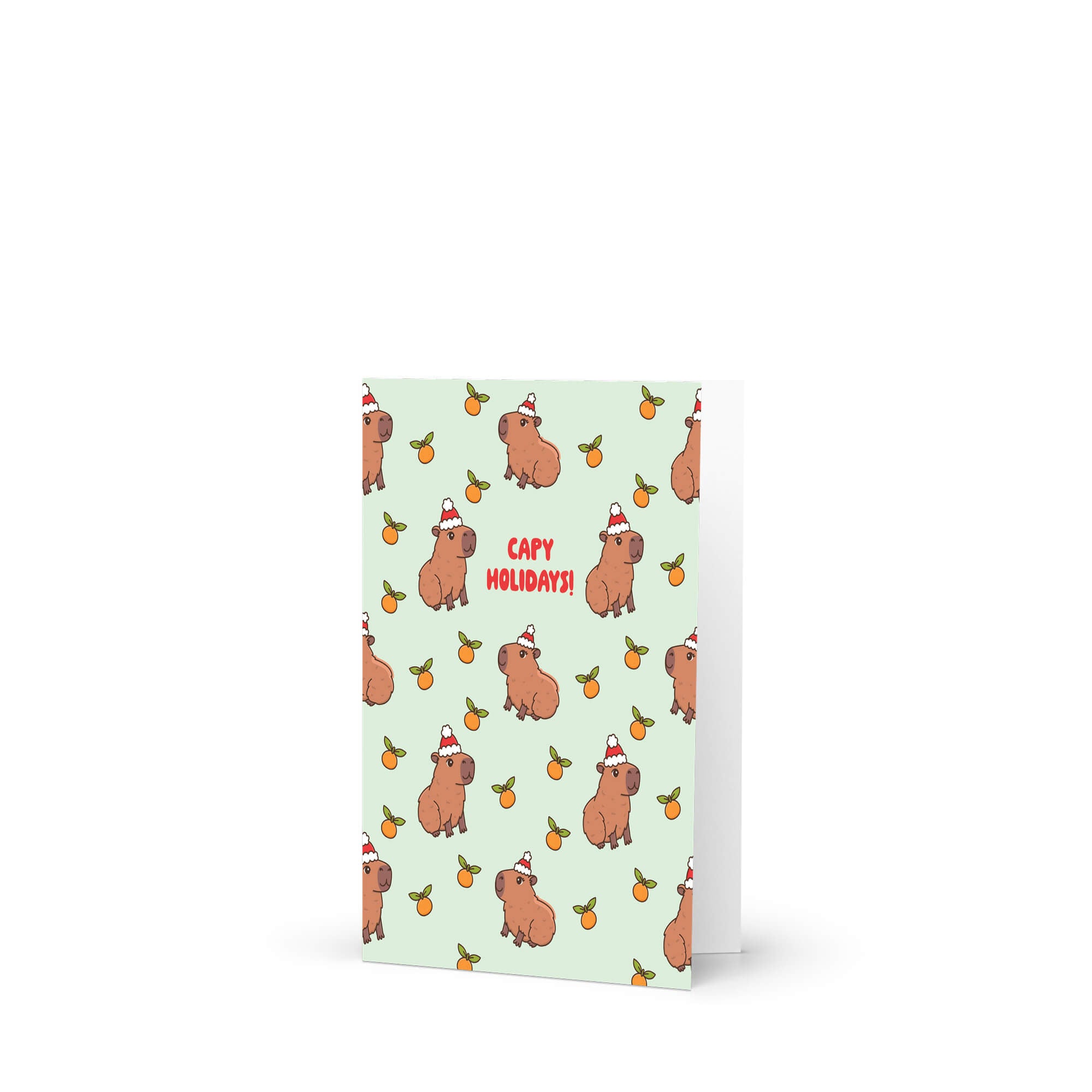 cute christmas card with Repeating pattern of capybaras in Santa hats with small oranges on a pale green background. Text reads a pun: “Capy Holidays.”