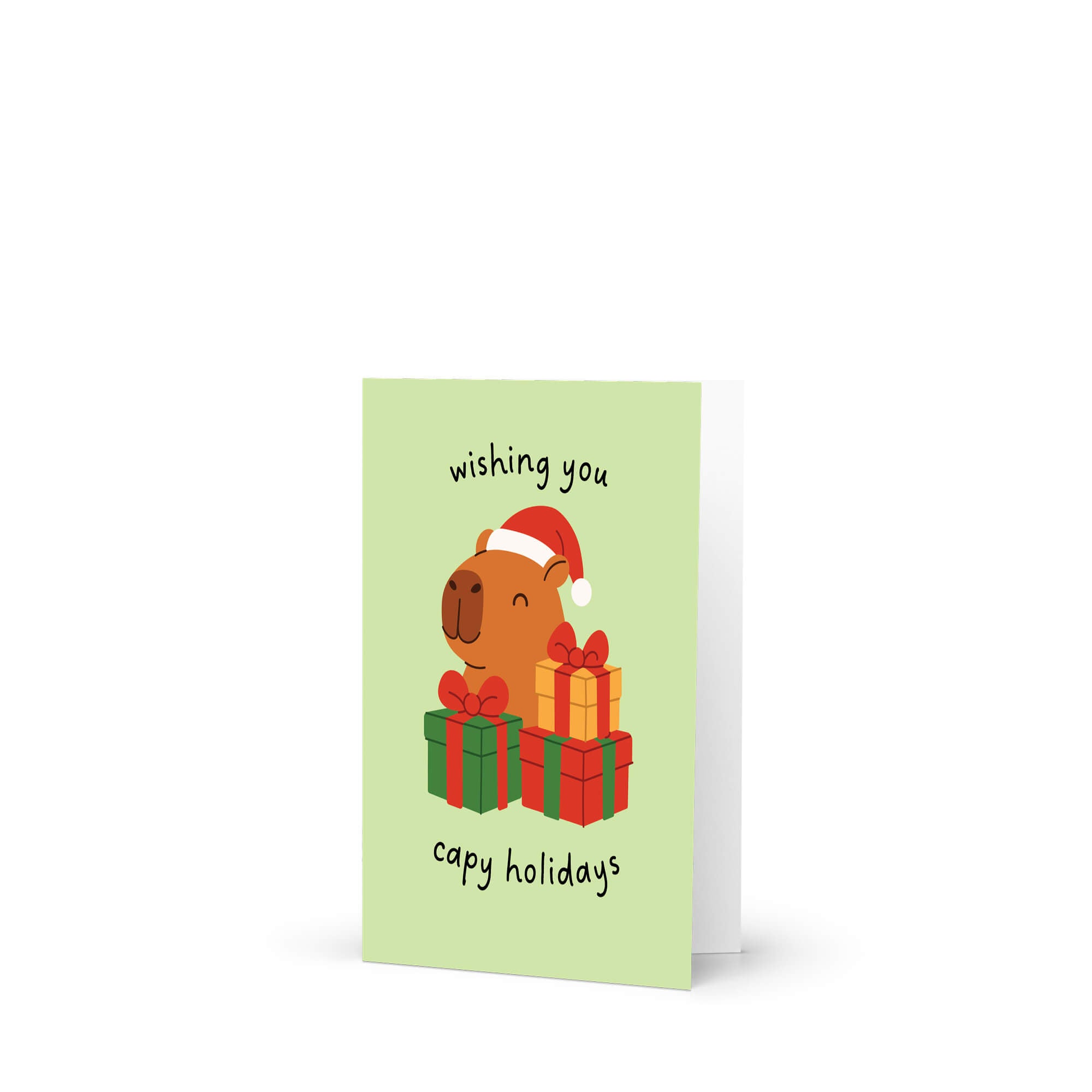cute unique Christmas card with a capybara wearing a Santa hat and surrounded by presents on a light green background with text pun: wishing you capy holidays