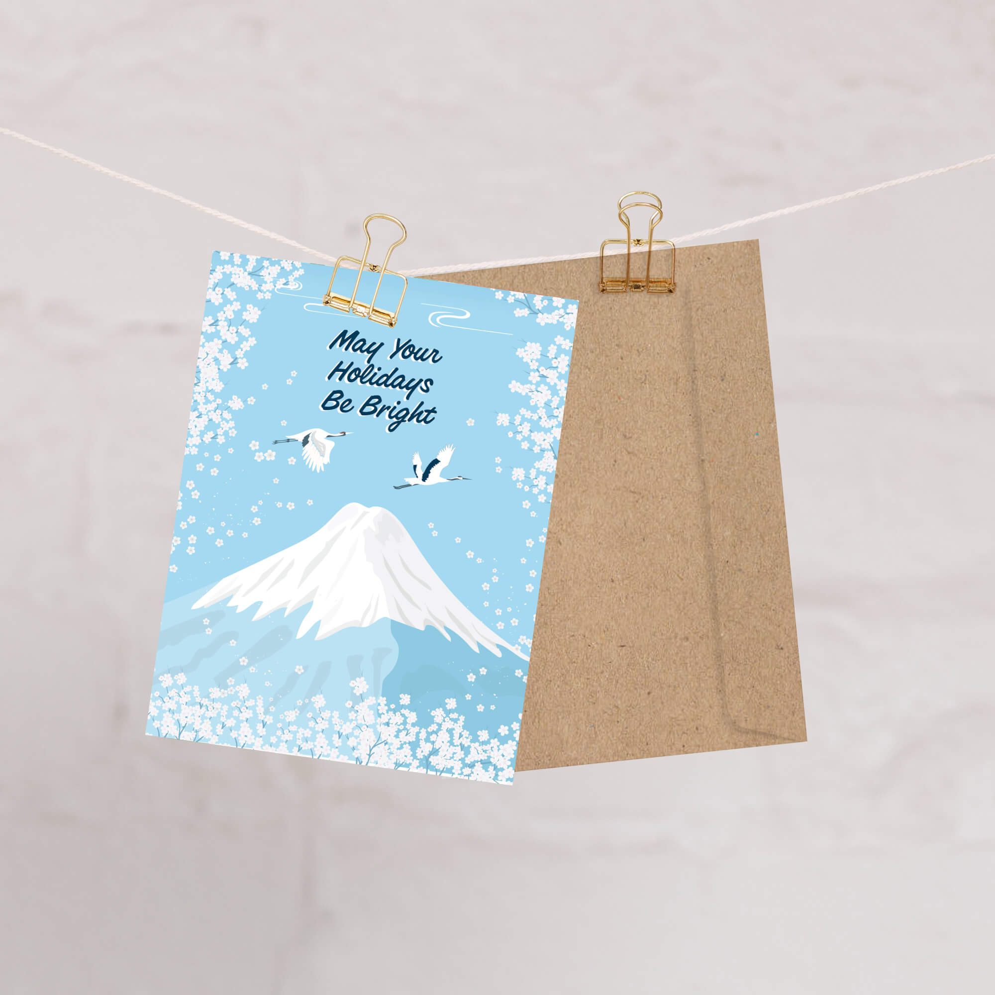japanese christmas card with a winter snowy Mount Fuji with cranes and white cherry blossoms; text “May Your Holidays Be Bright.”