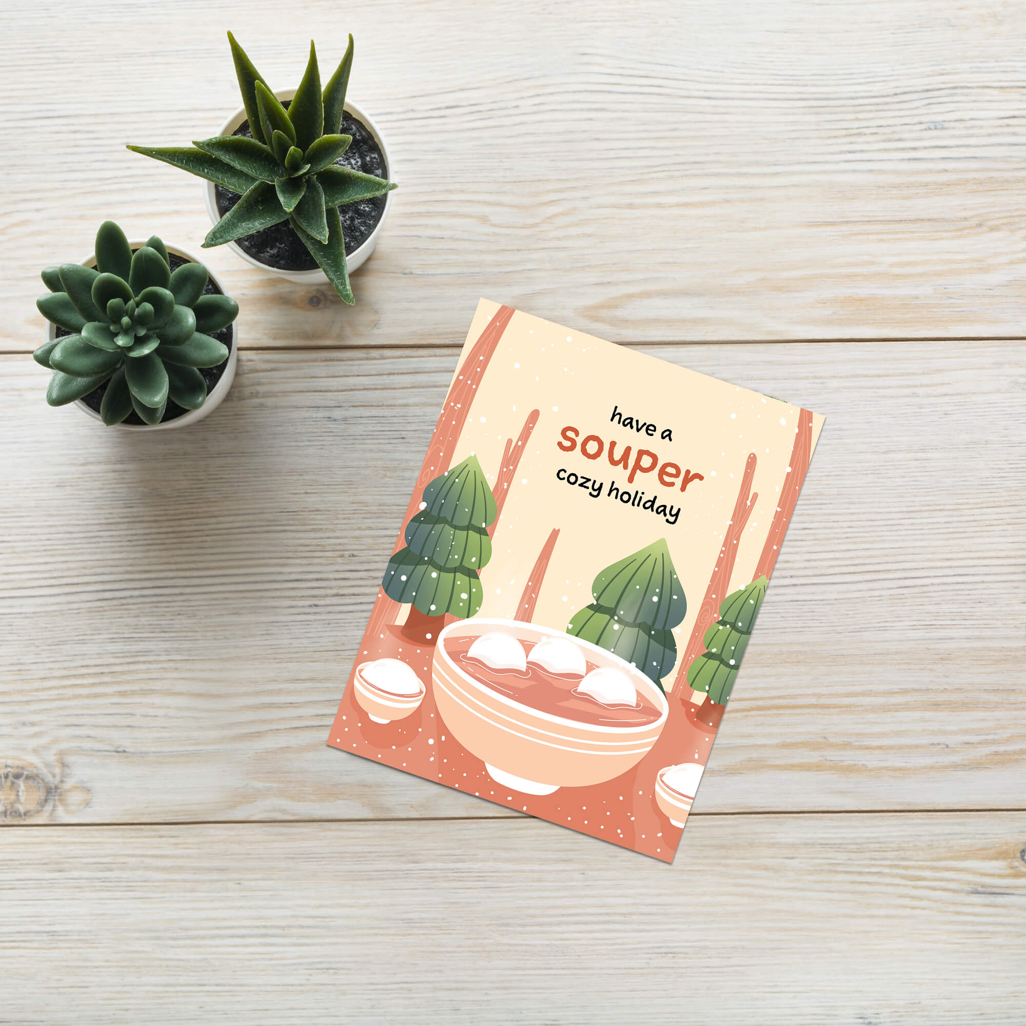 unique holiday Greeting card with a bowl of soup and winter scene, text 'have a souper cozy holiday'. 