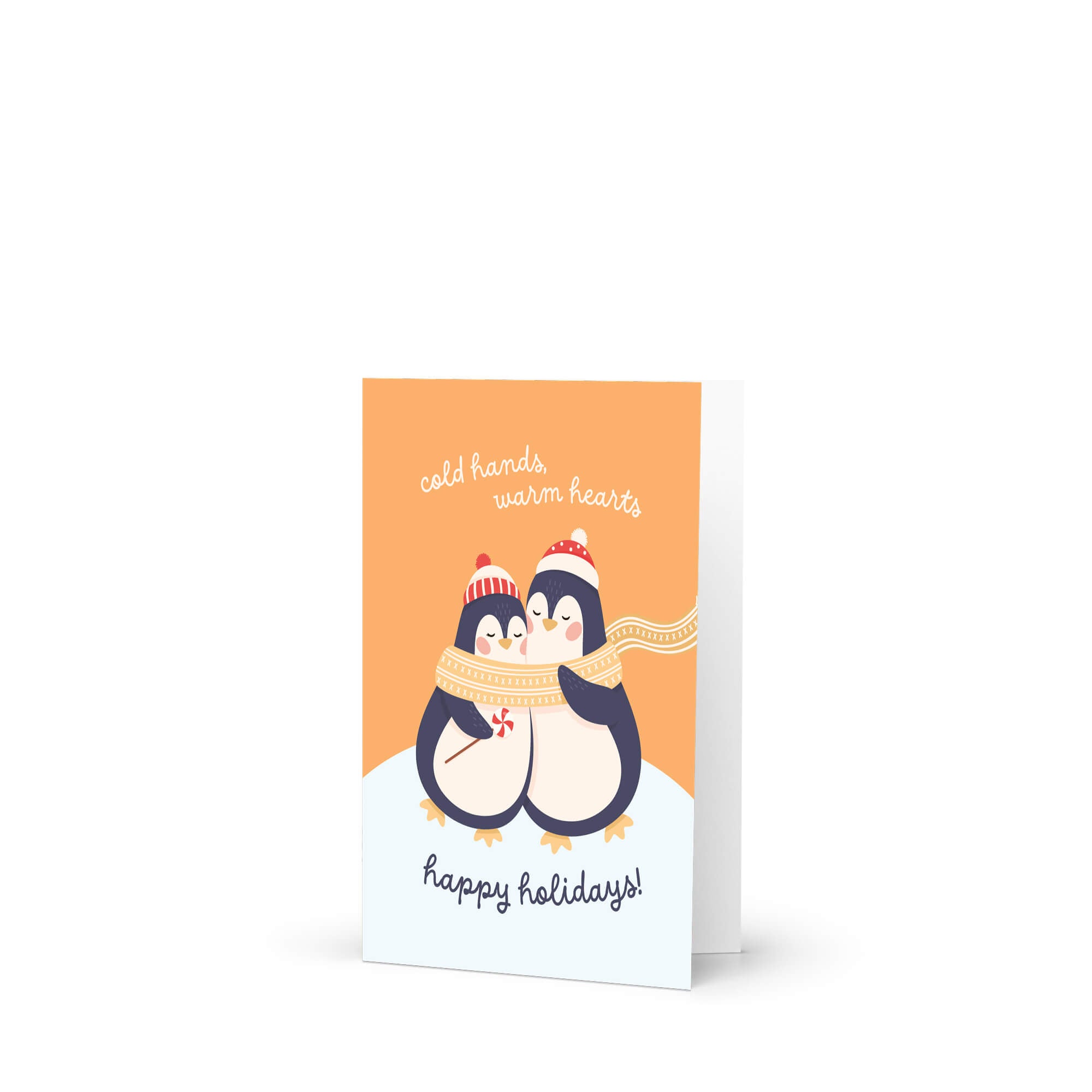 unique holiday card with two penguins hugging, wearing scarves and hats, on an orange background with text "Two penguins in knit hats sharing a scarf; text “cold hands, warm hearts — happy holidays!”"