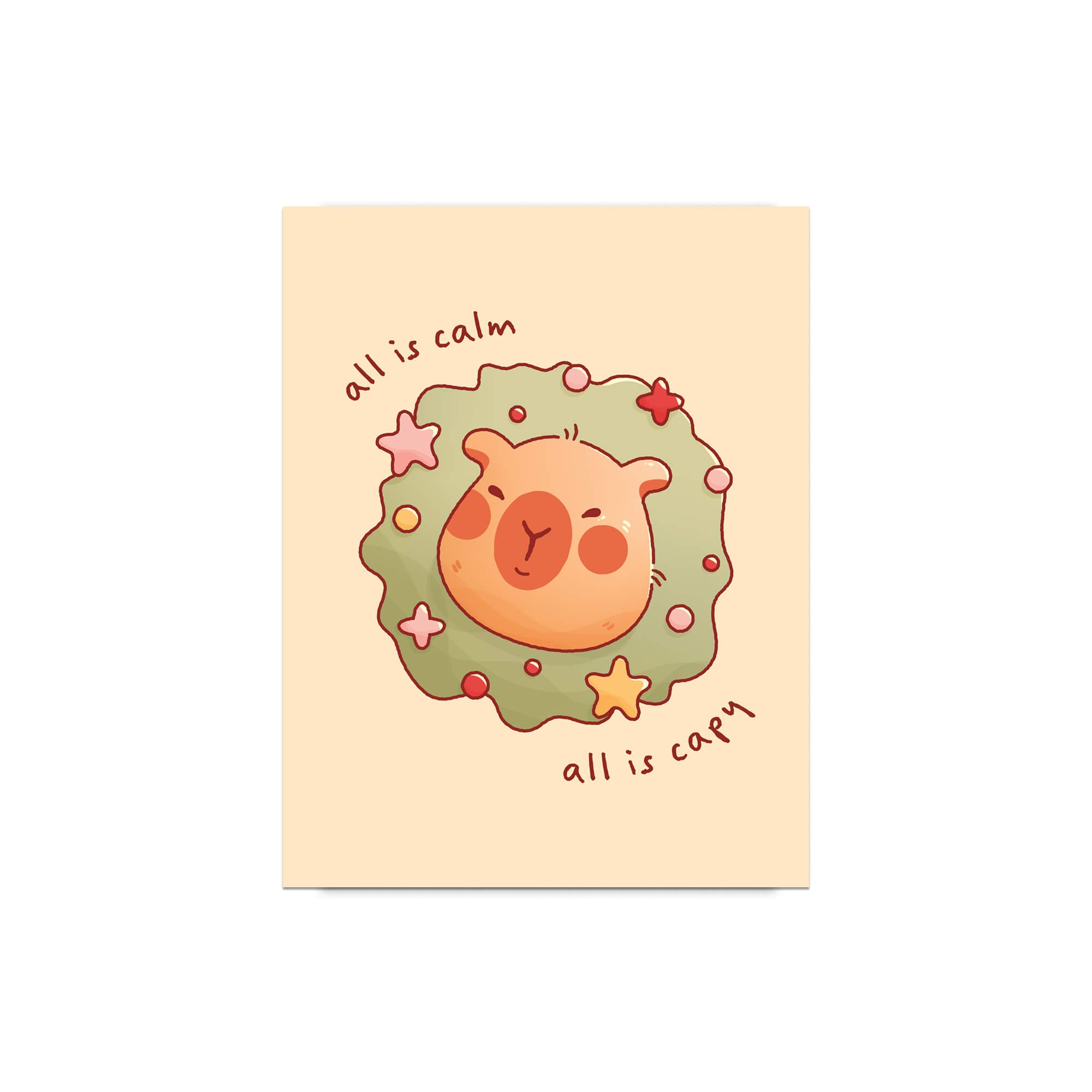 cute christmas card with a Capybara nestled in green holiday wreath with stars, text “all is calm, all is capy.”