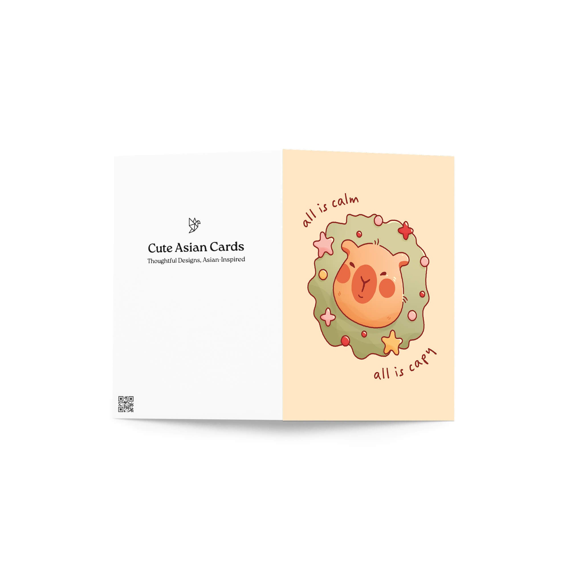 cute christmas card with a Capybara nestled in green holiday wreath with stars, text “all is calm, all is capy.”