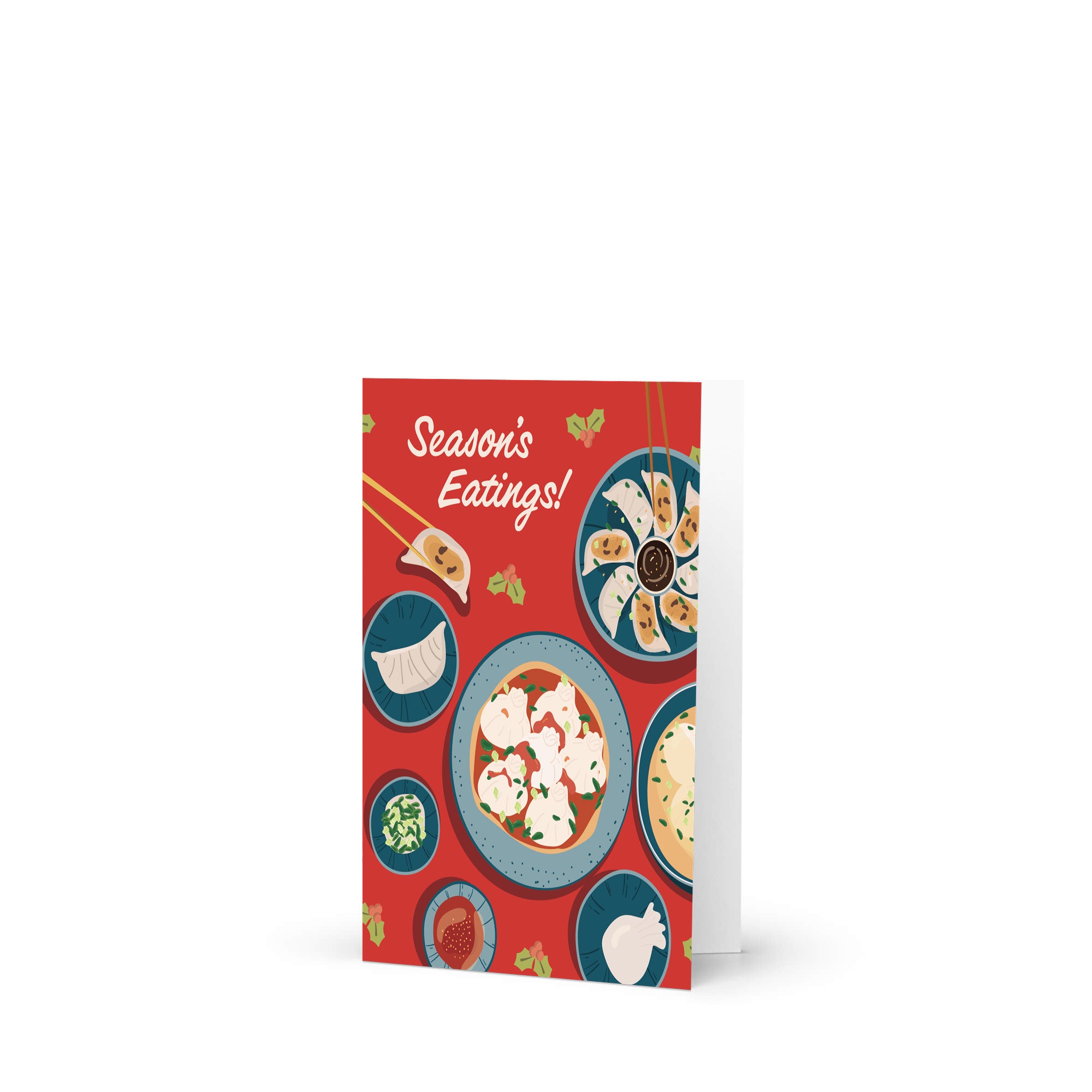 cute christmas card showing a red table with plates of dumplings and sauces, text “Season’s Eatings!”