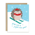 cute unique christmas Greeting card with a hedgehog skiing and text 'glide into a joyful new year!' on a snowy background.