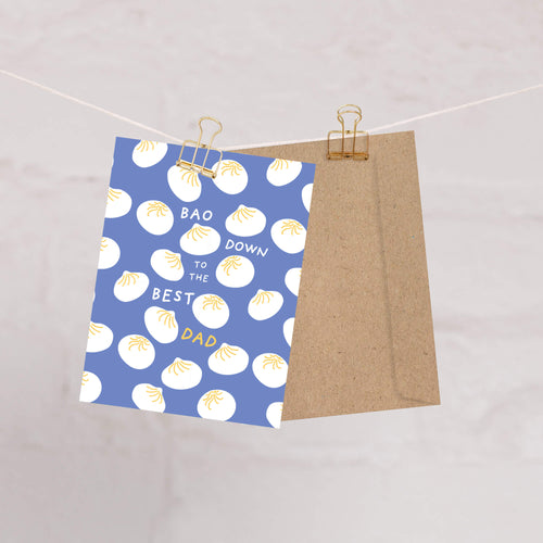 funny father's day card with white dumplings pattern and text "bao down to the best dad" pun on a blue background