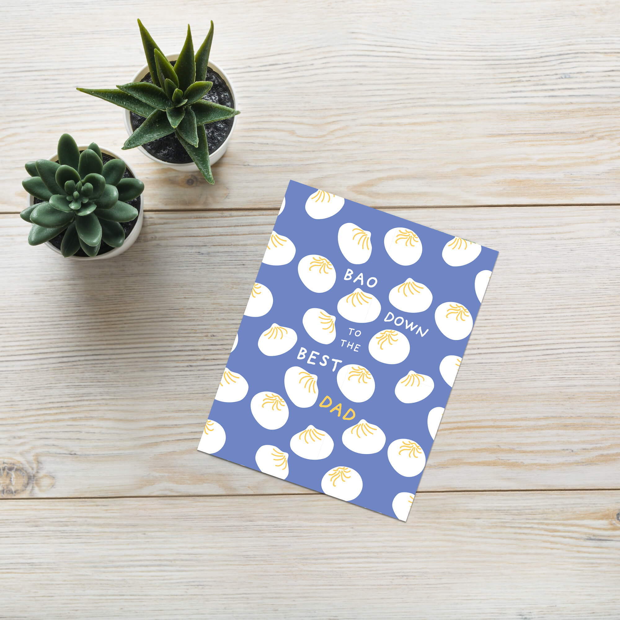 funny father's day card with white dumplings pattern and text "bao down to the best dad" pun on a blue background