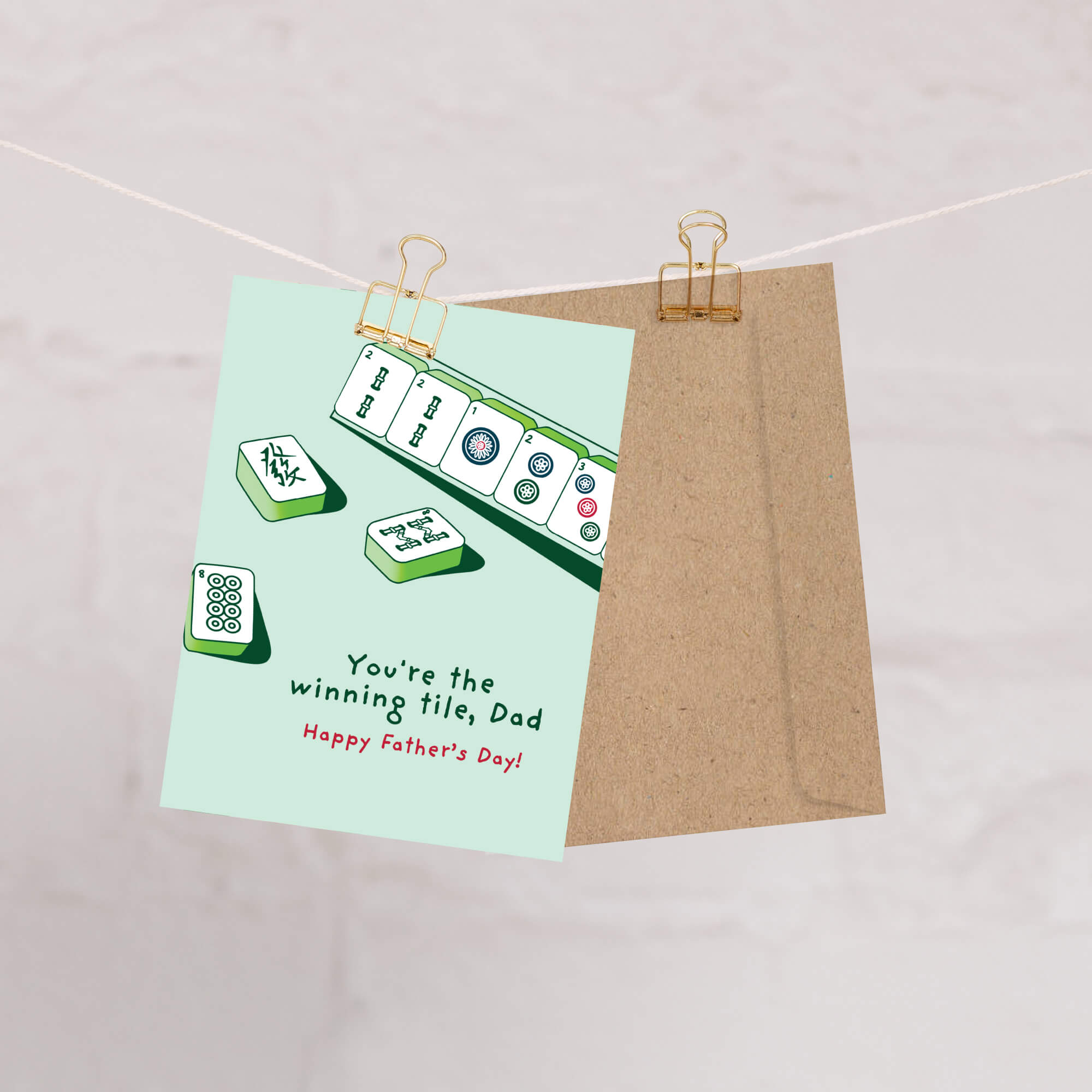 Father's Day card with Mahjong tiles and text "youre the winning tile dad" on a light green background
