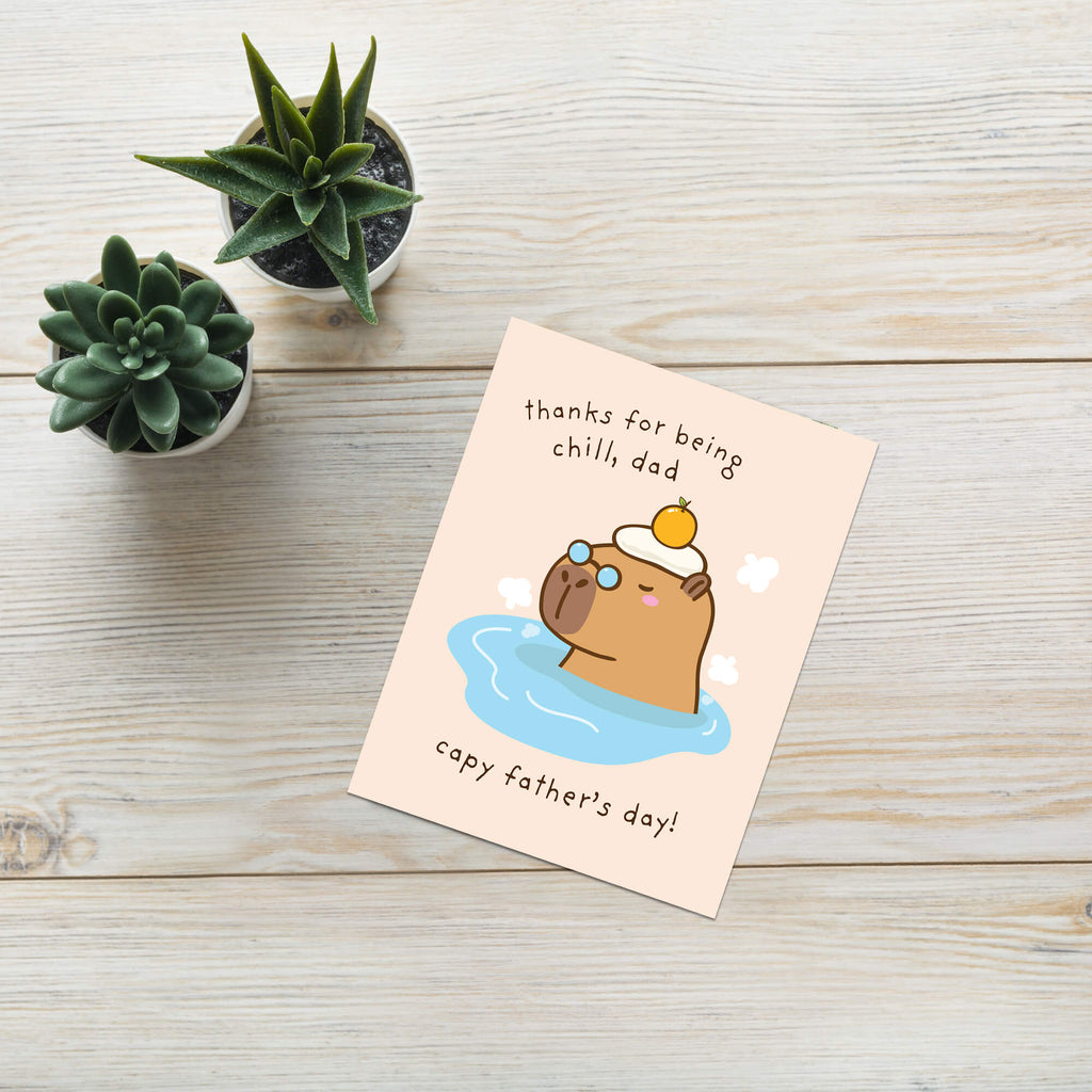 funny Father's Day card with a cute capybara animal in water and text 'thanks for being chill, dad capy father's day!' on a beige background.