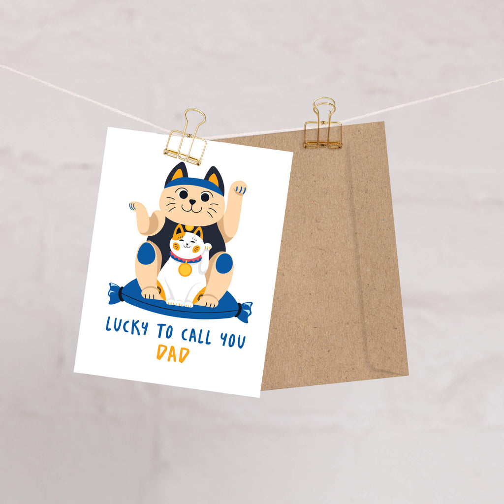 cute father's day card with japanese maneki neko lucky cat design and text 'Lucky to call you Dad' on a white background.