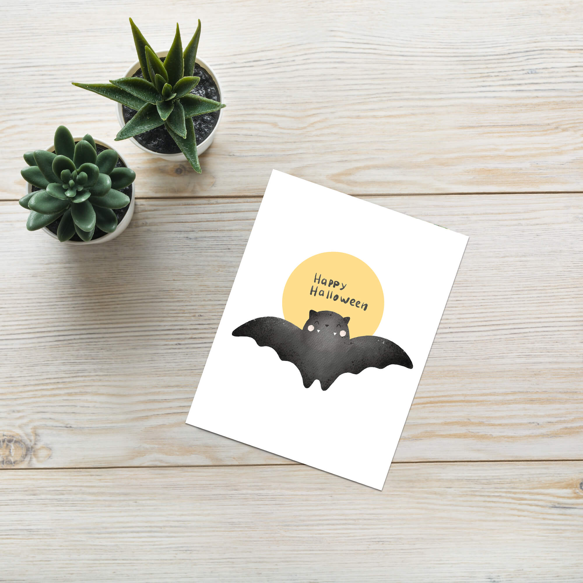 cute Halloween card with a bat and 'Happy Halloween' text on a yellow moon