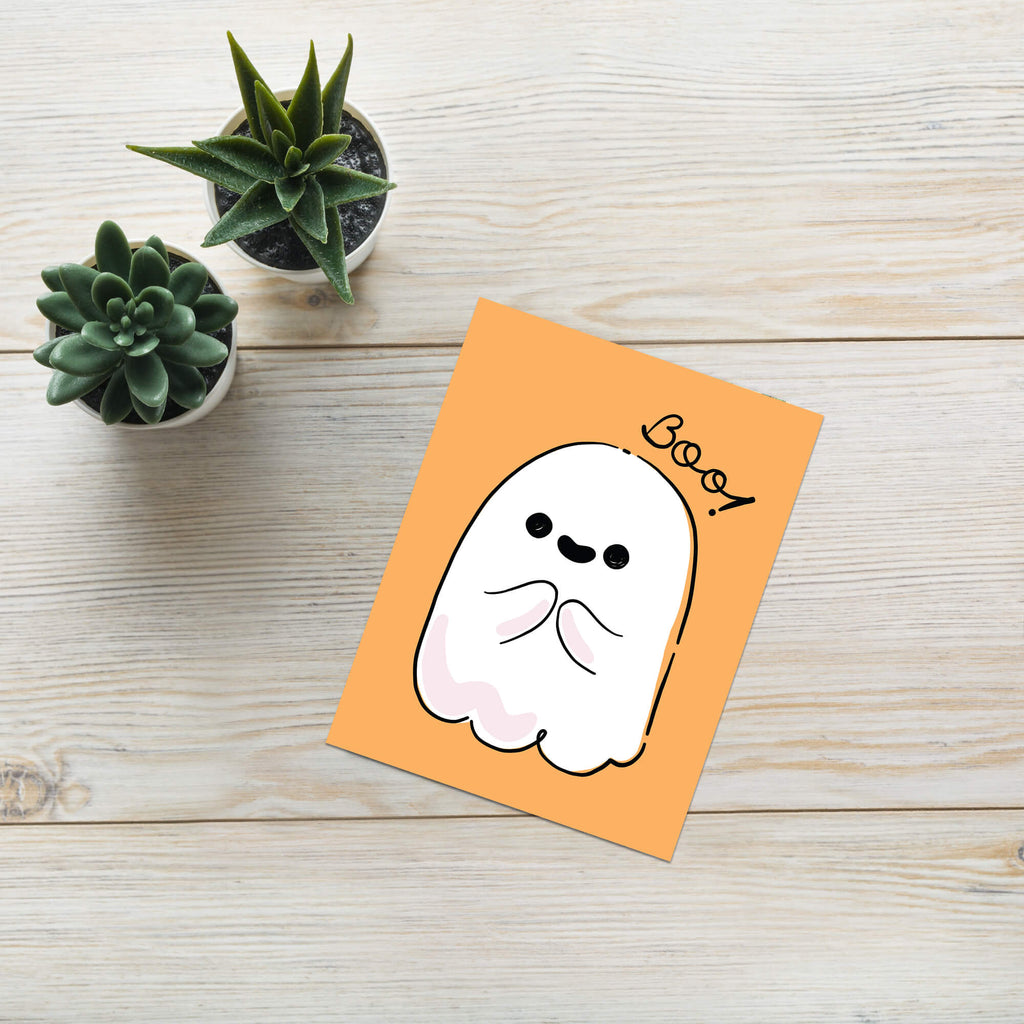 Halloween-themed card with a cute ghost illustration and 'Boo!' text on an orange background.