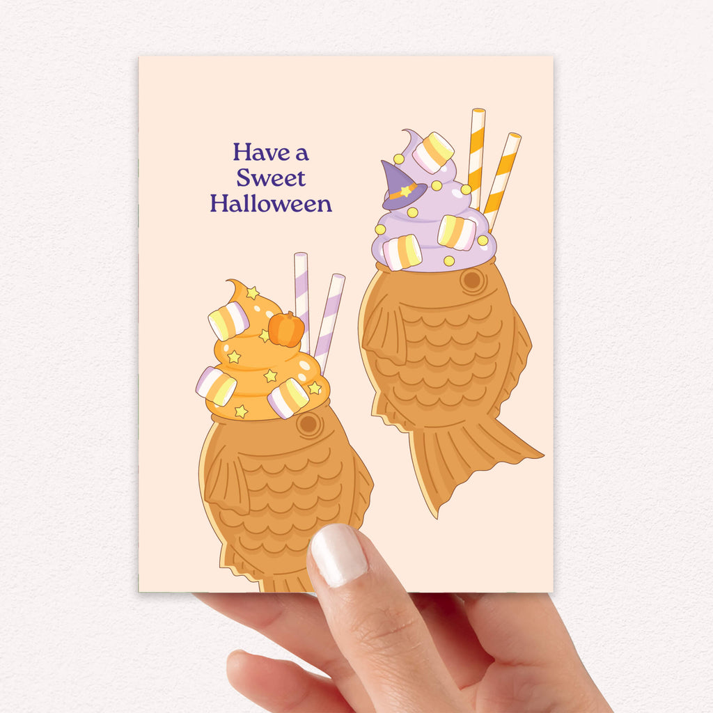 kawaii japanese Halloween-themed greeting card with ice cream taiyaki cones and text on a beige background, 