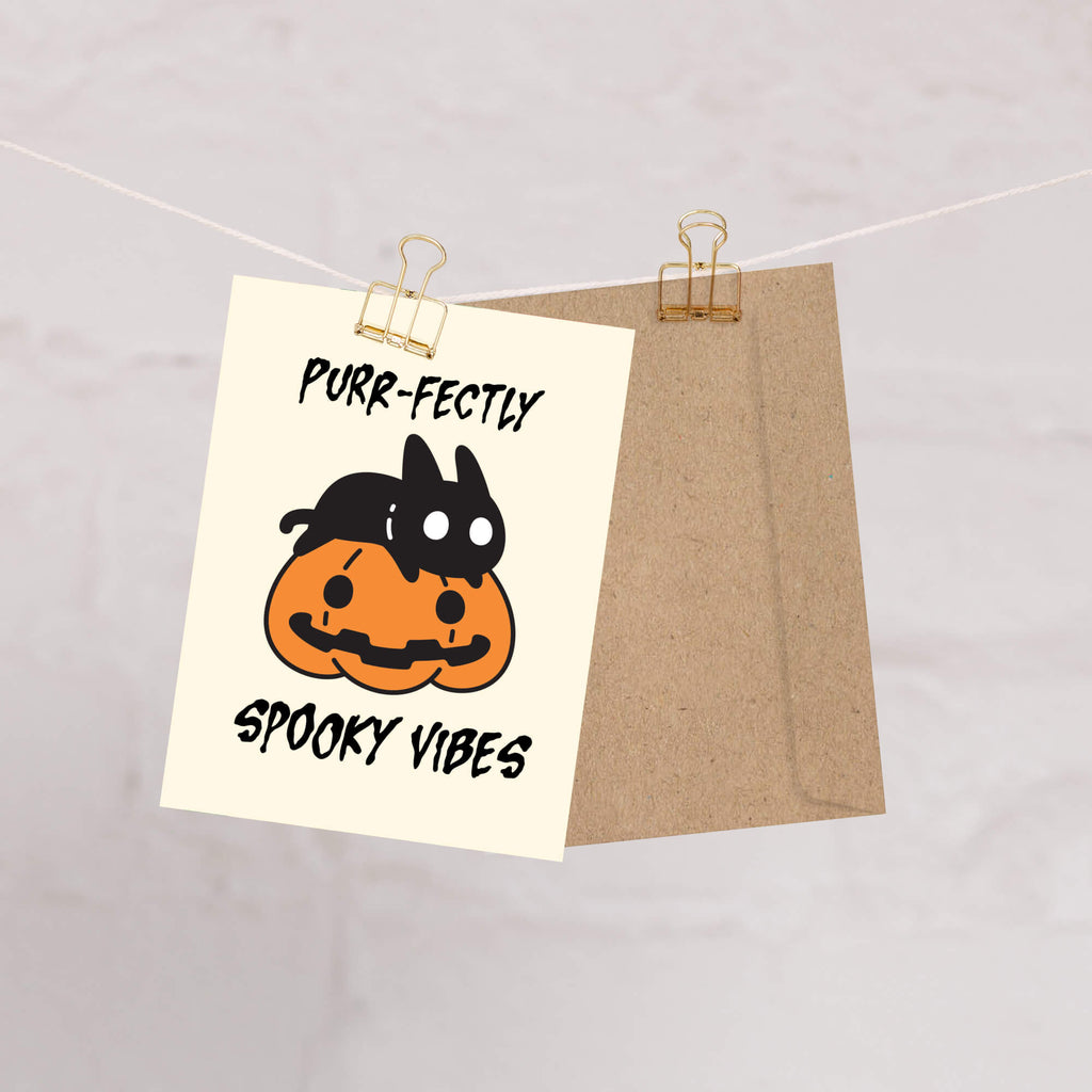 Halloween-themed towel with a cat in a pumpkin design and text on a light background