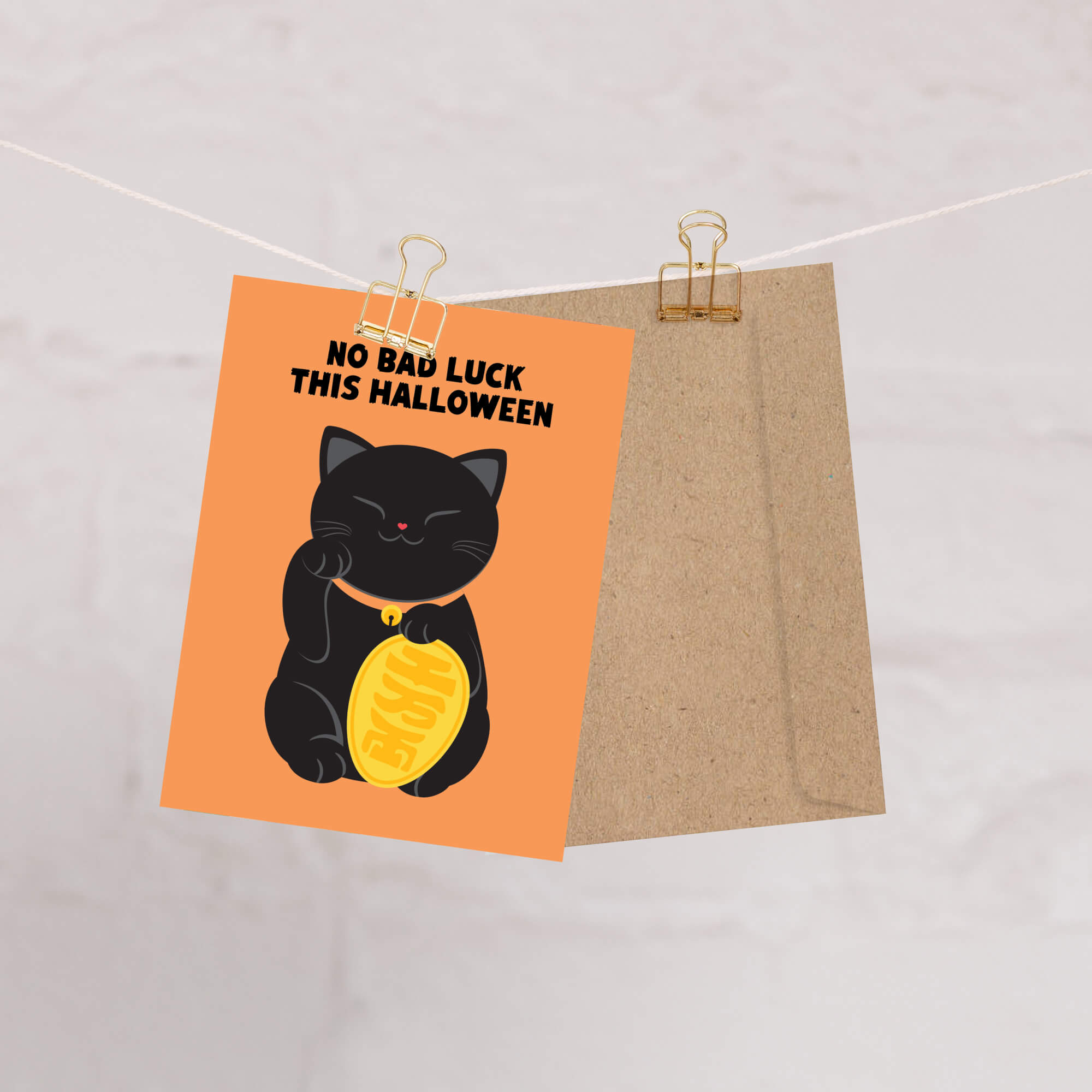 cute halloween Greeting card with a black cat holding a gold coin and 'No Bad Luck This Halloween' text on an orange background.