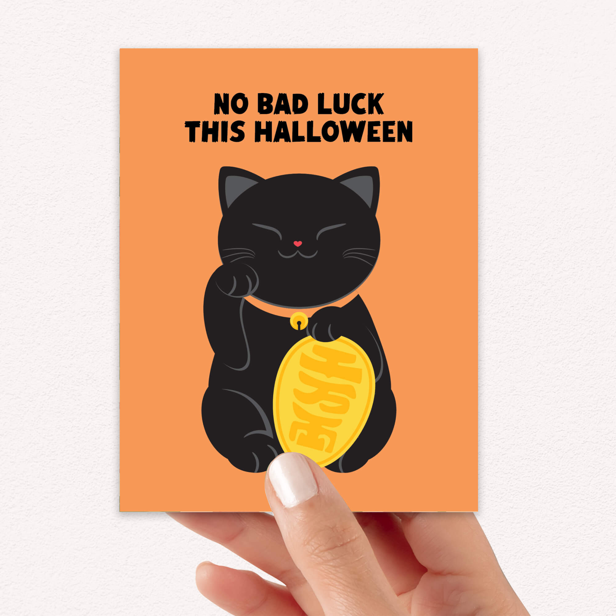 cute halloween Greeting card with a black cat holding a gold coin and 'No Bad Luck This Halloween' text on an orange background.