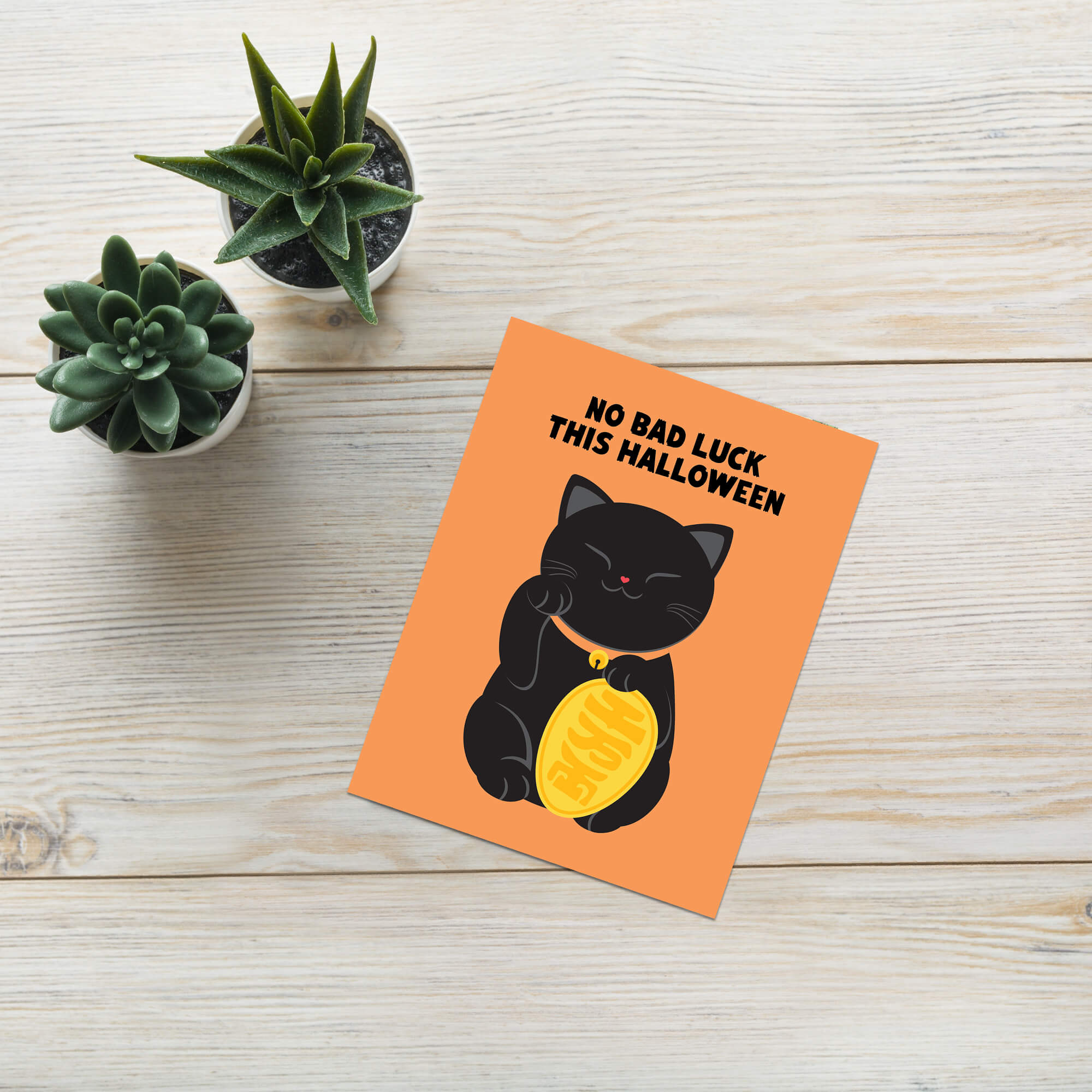 cute halloween Greeting card with a black cat holding a gold coin and 'No Bad Luck This Halloween' text on an orange background.